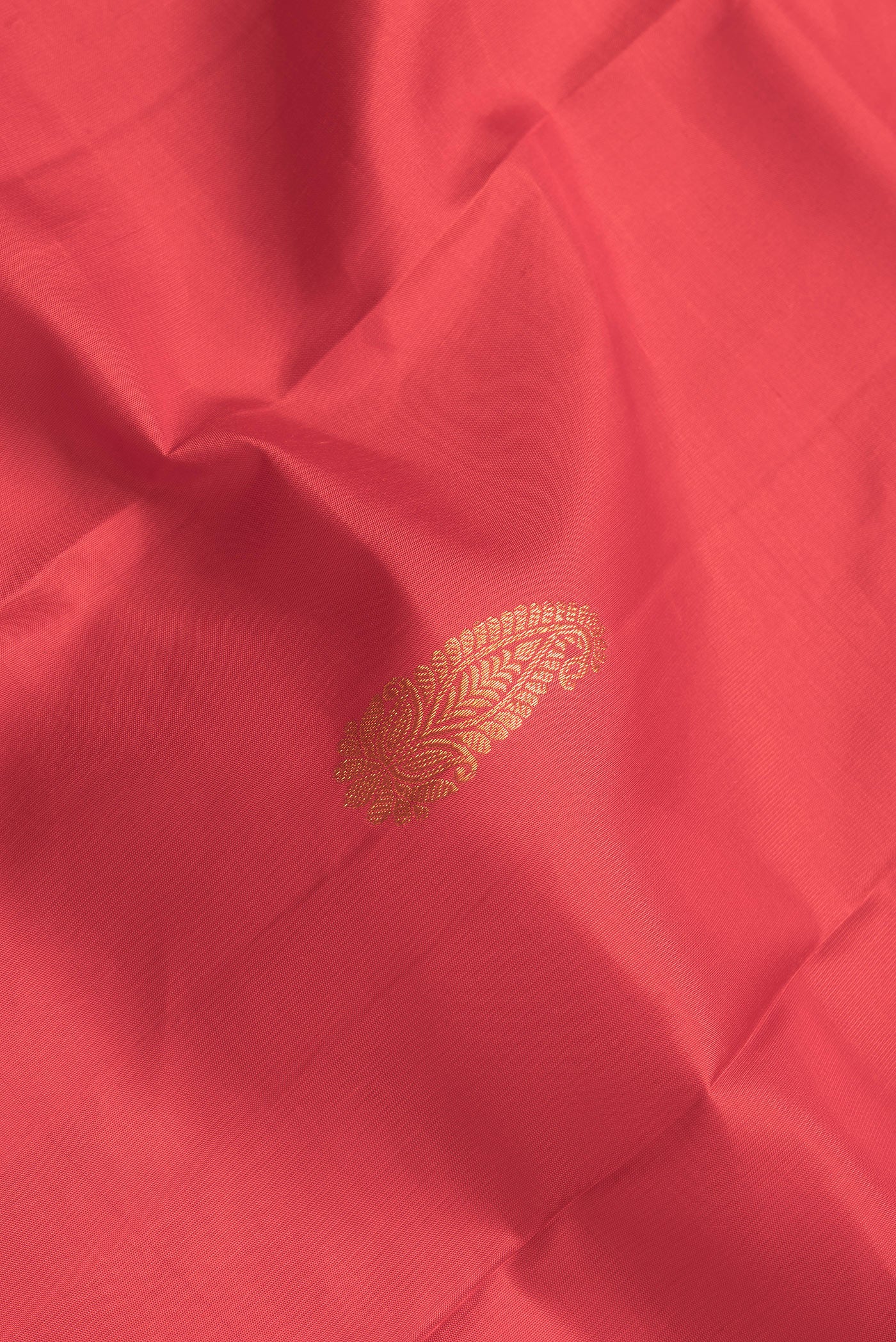 Close up of Red Dual Tone Kanjivaram Silk Saree with Zari Butta on the body and Zari Border.  displaying folds