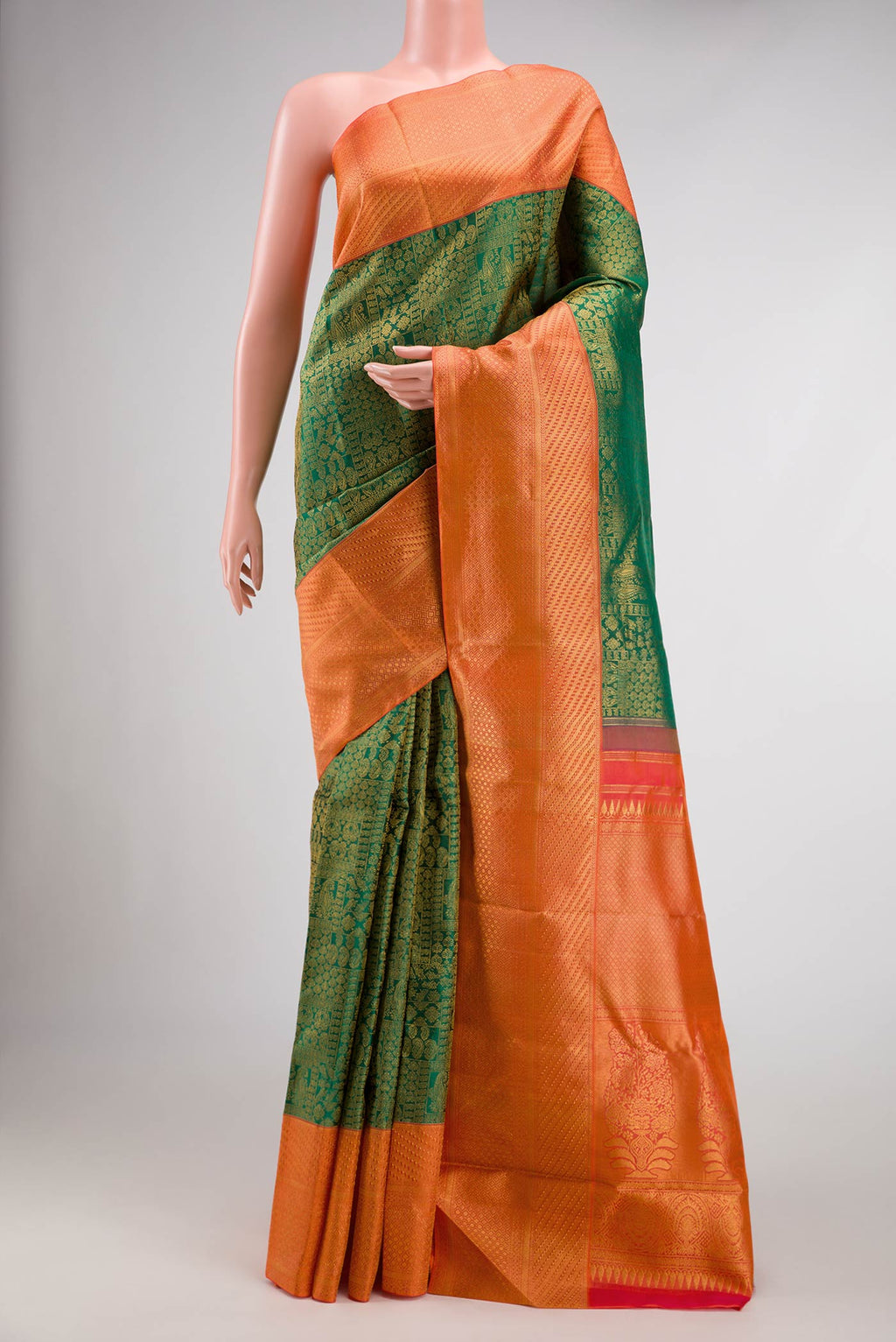 Green Dual Tone Kanchipuram Silk Saree with Zari Brocade on the body and Zari Border.  displayed on a mannequin