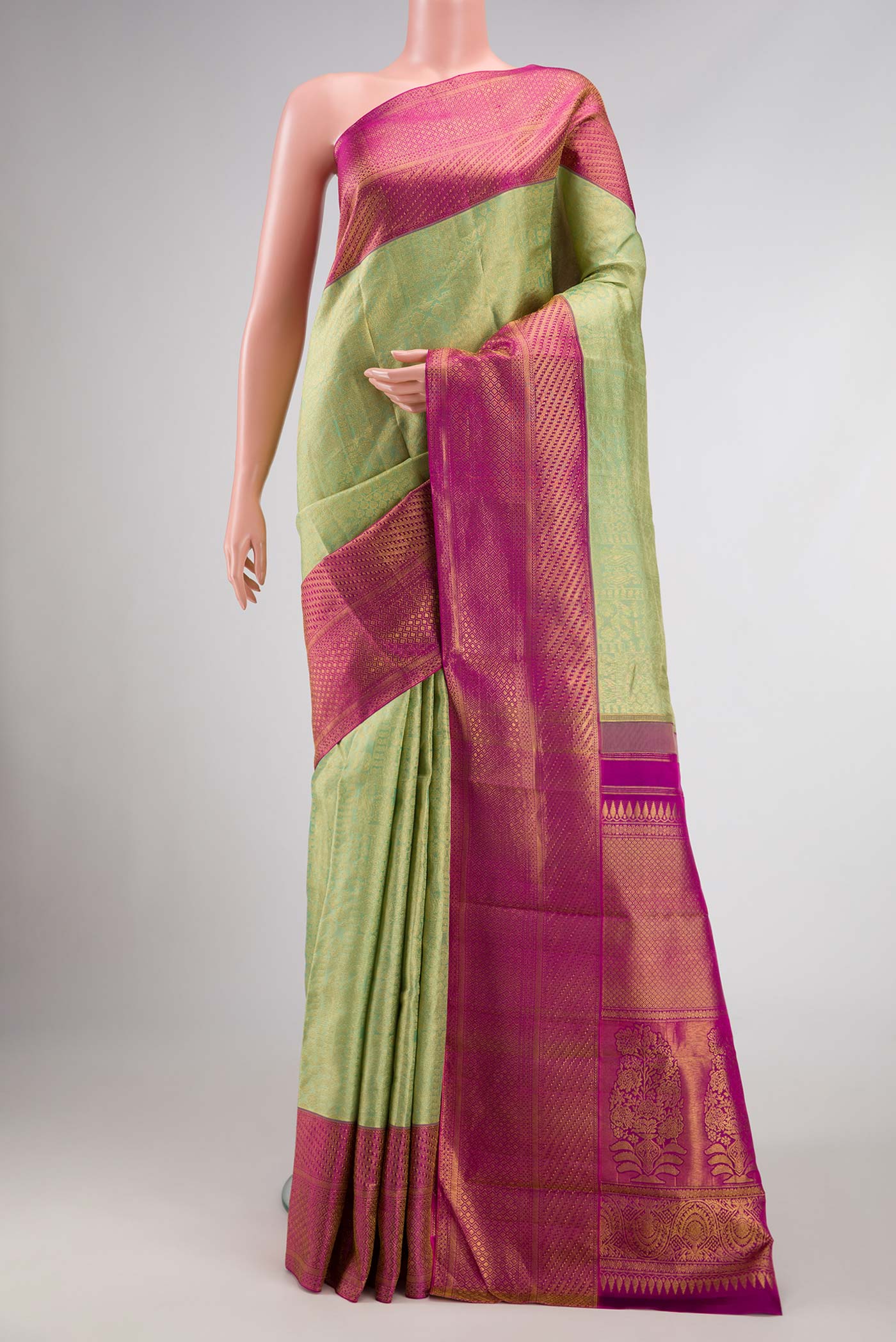 Pista Green Dual Tone Kanchipuram Silk Saree with Zari Brocade on the body and Zari Border.  displayed on a mannequin