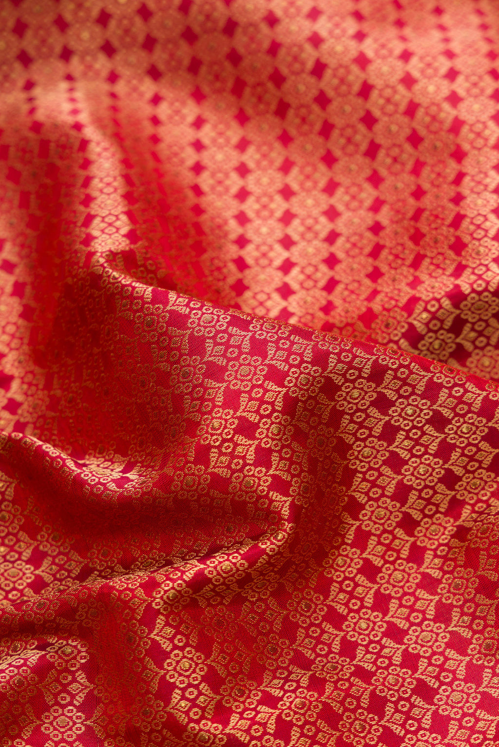 Close up of Pure Silk Pure Zari Maroon Dual Tone Kanchipuram Saree with Jacquard design on the body and Fancy Border.  displaying folds