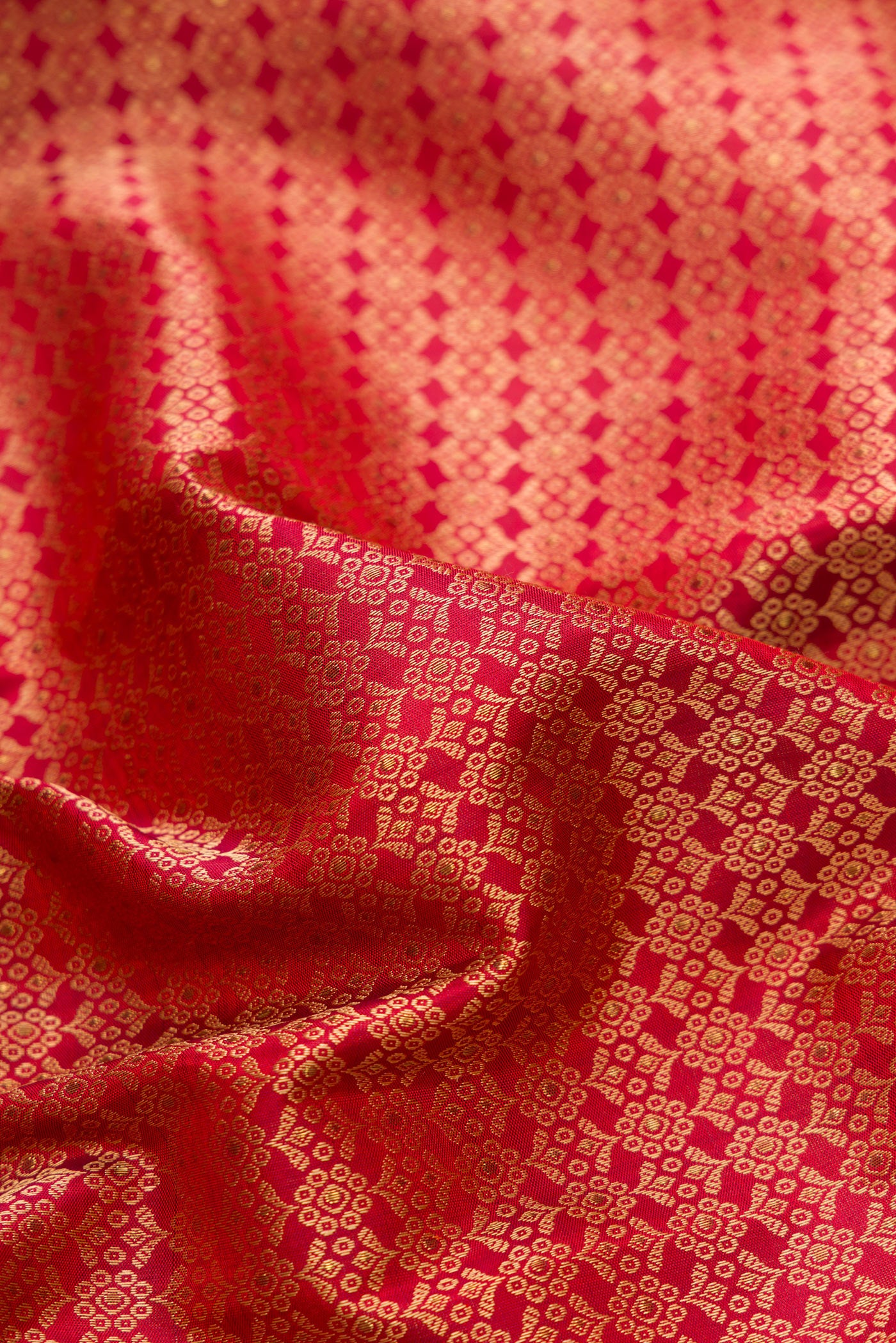 Close up of Pure Silk Pure Zari Maroon Dual Tone Kanchipuram Saree with Jacquard design on the body and Fancy Border.  displaying folds