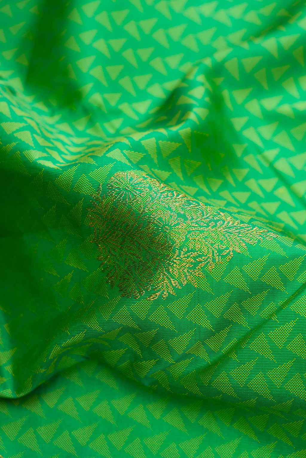 Close up of Green Dual Tone Kanjivaram Silk Saree with Jacquard With Zari Butta on the body and Zari Border.  displaying folds