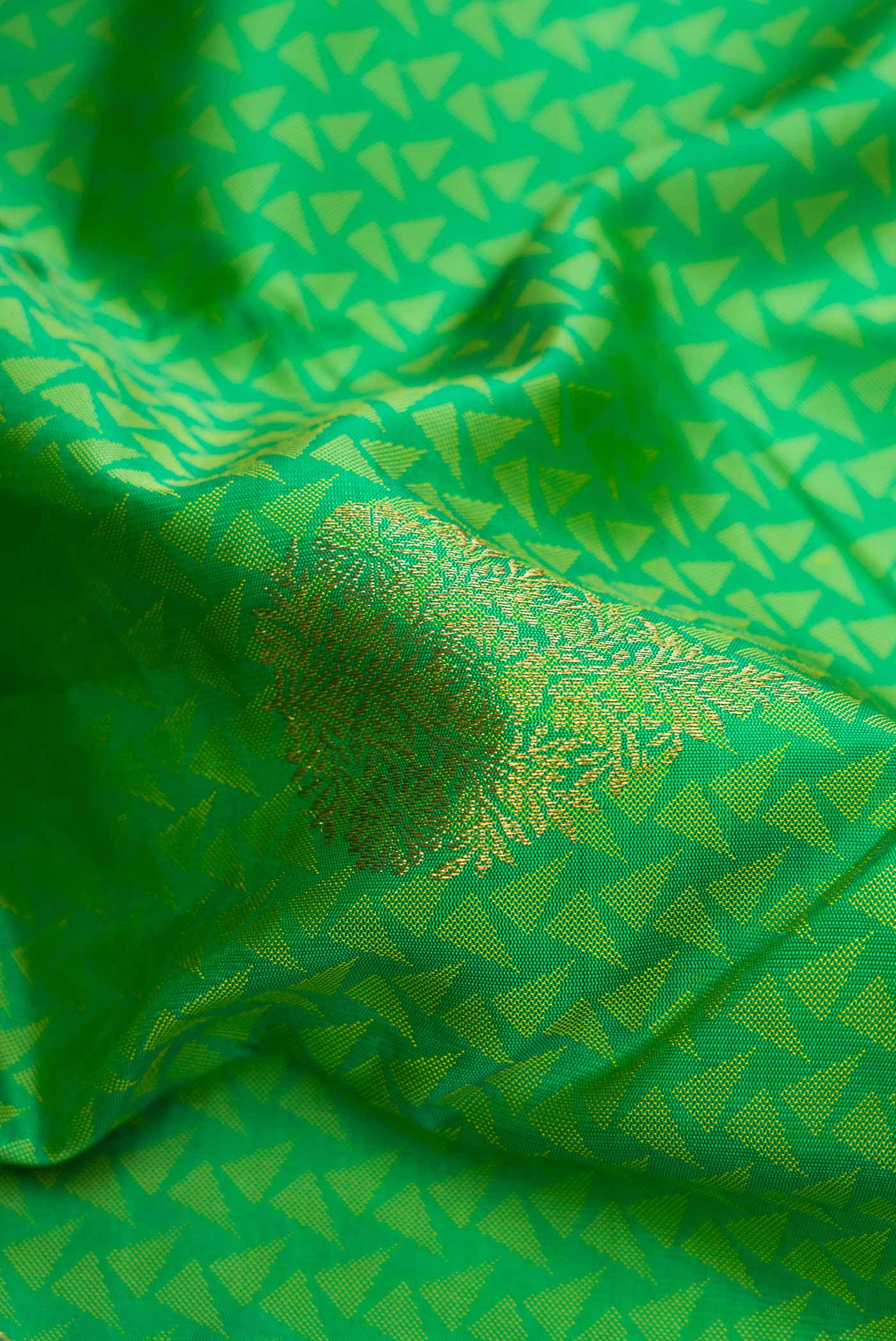 Close up of Green Dual Tone Kanjivaram Silk Saree with Jacquard With Zari Butta on the body and Zari Border.  displaying folds