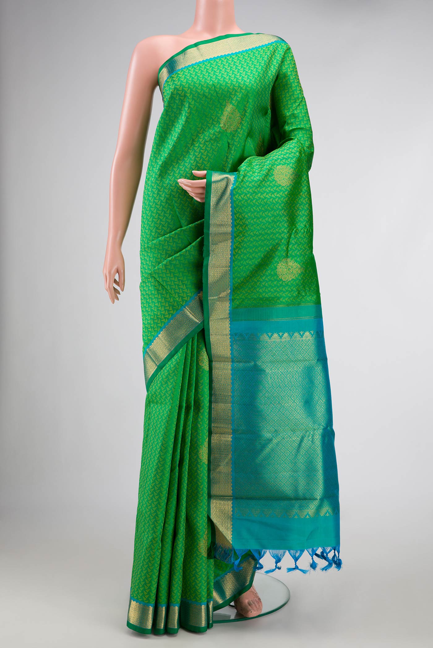 Green Dual Tone Kanjivaram Silk Saree with Jacquard With Zari Butta on the body and Zari Border.  displayed on a mannequin