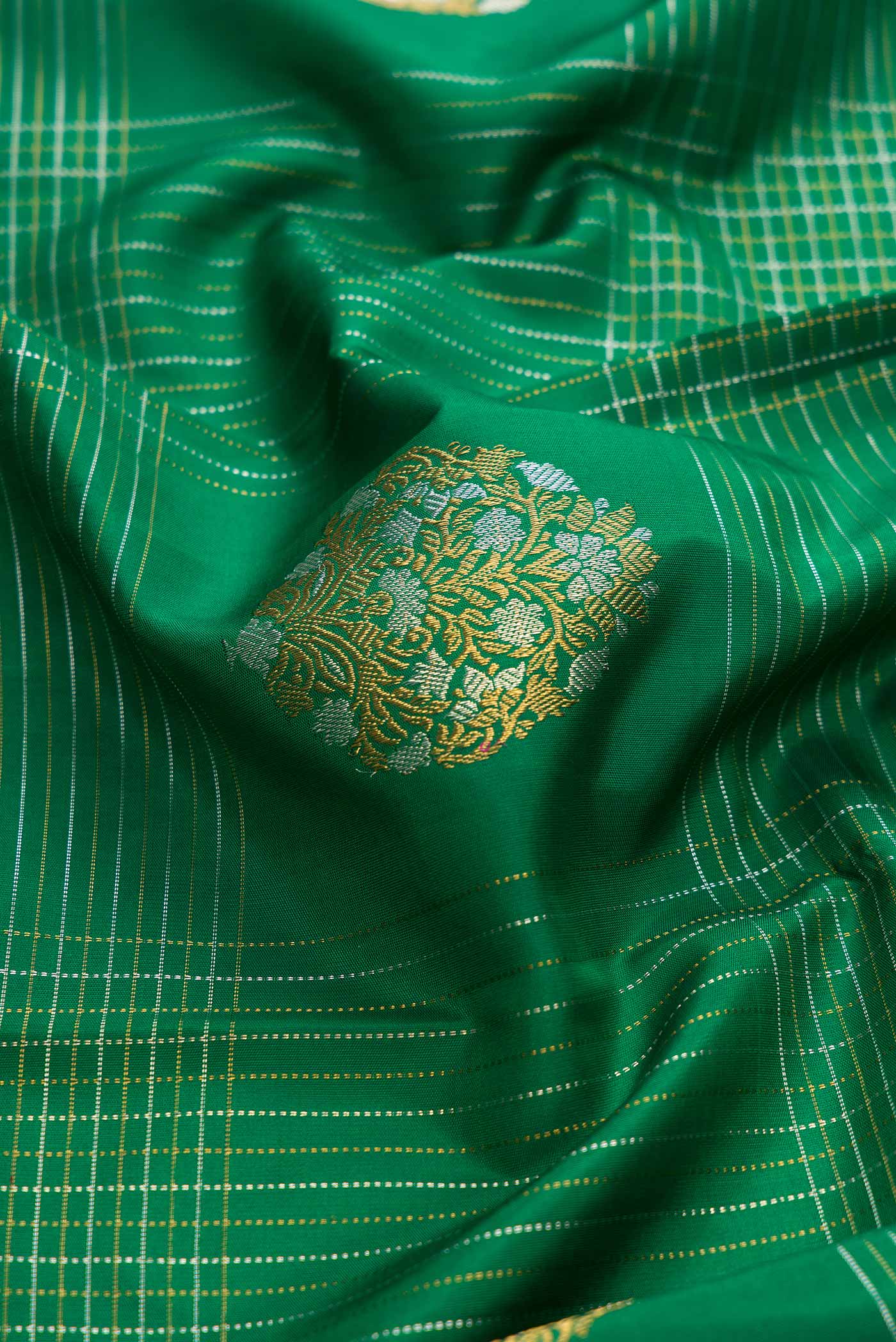 Close up of Pure Silk Pure Zari Green Dual Tone Kanchipuram Saree with Stripes on the body and Zari Border displaying folds
