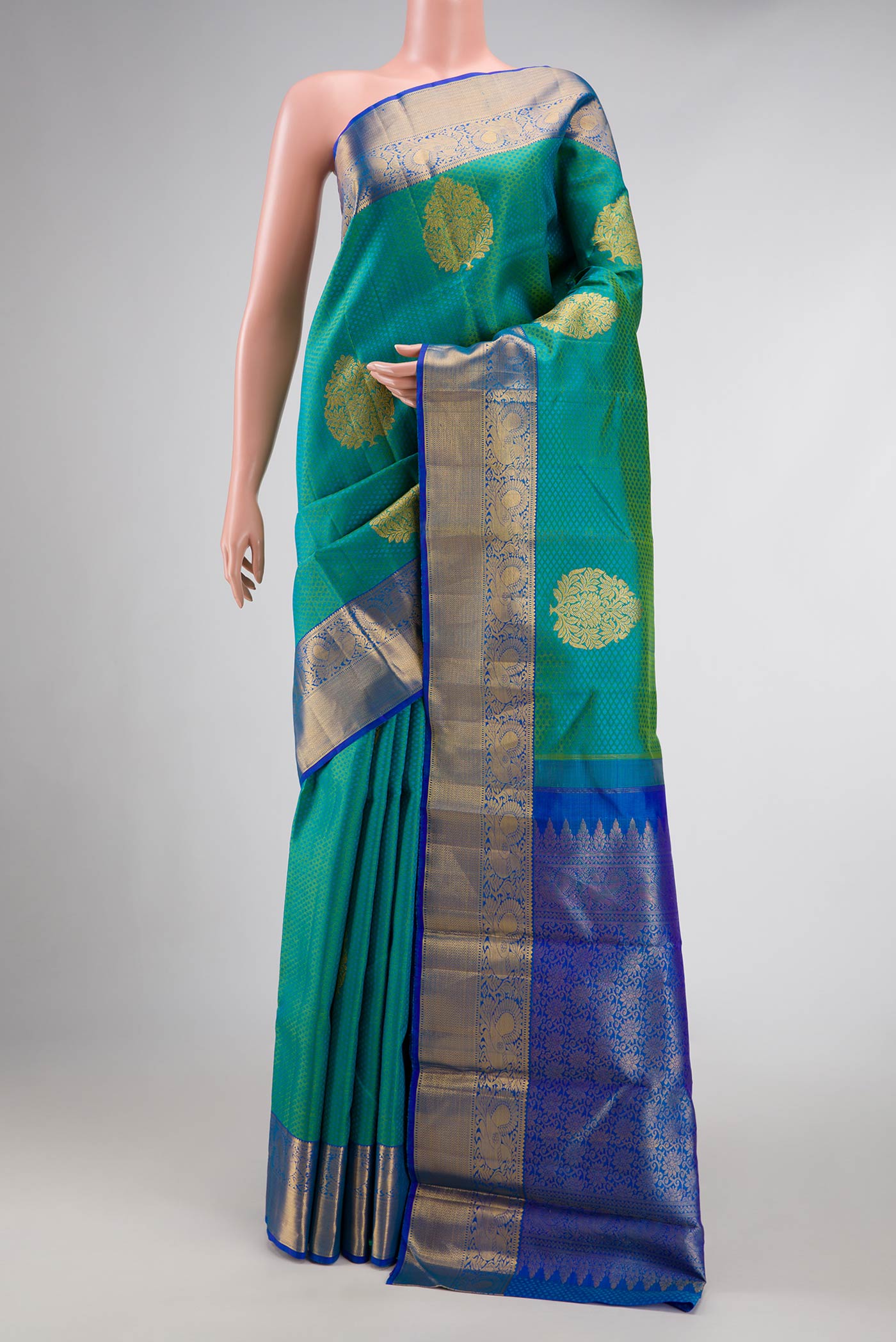 Green Dual Tone Kanchipuram Silk Saree with Jacquard With Zari Butta on the body and Zari Border.  displayed on a mannequin