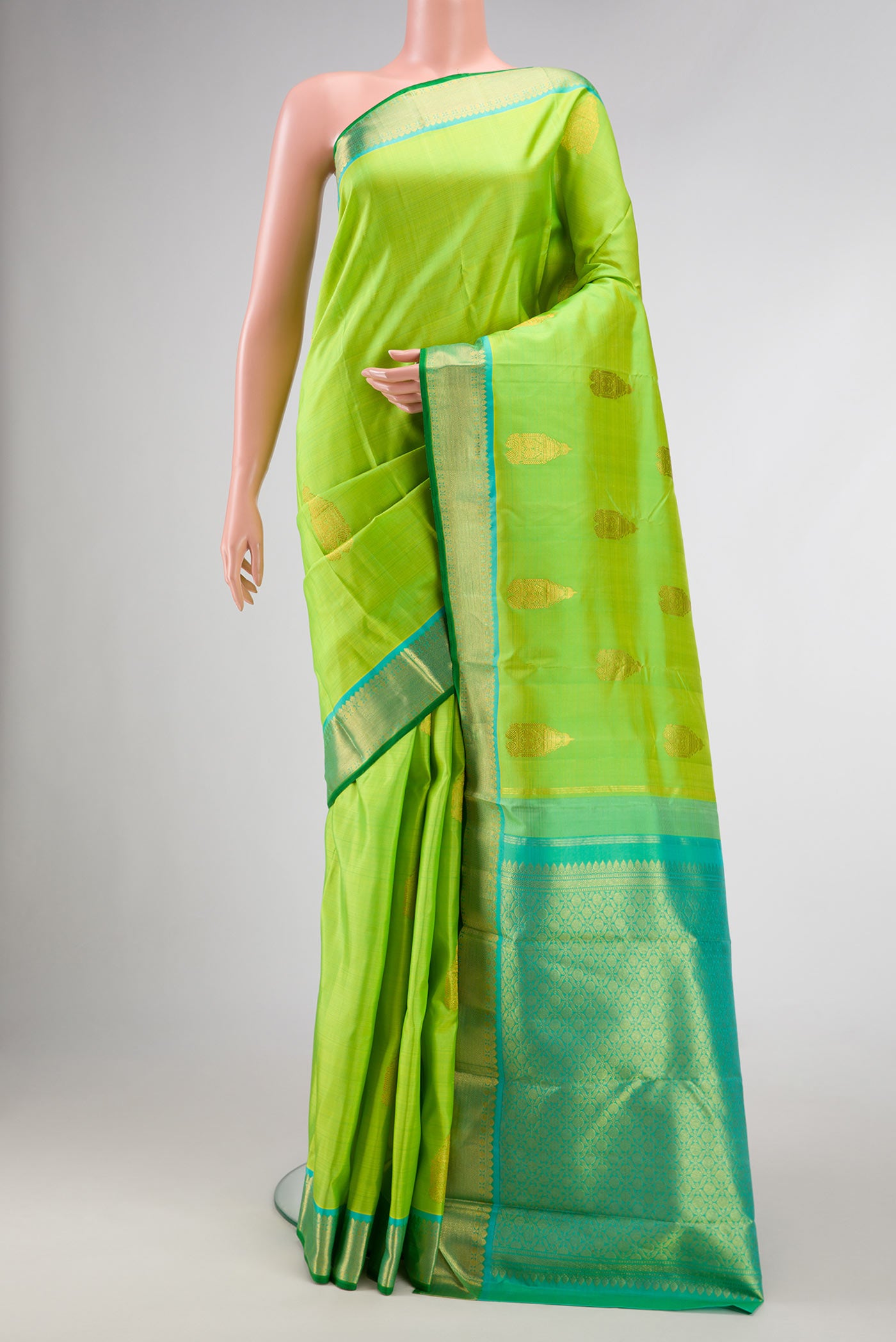 Parrot Green Dual Tone Kanchipuram Silk Saree with Zari Butta on the body and Zari Border.  displayed on a mannequin