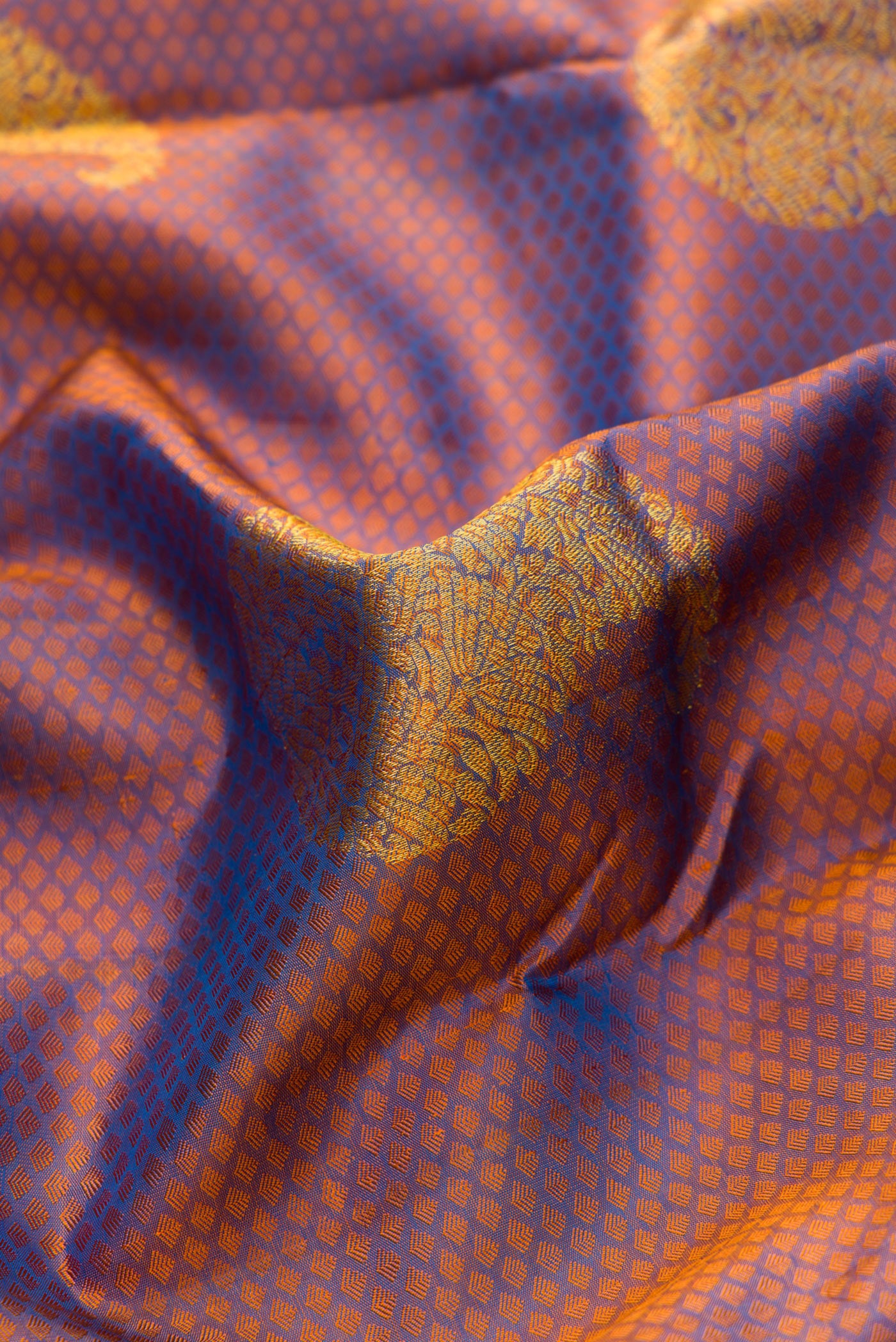 Close up of Peacock Blue Dual Tone Kanchipuram Silk Saree with Jacquard With Zari Butta on the body and Zari Border.  displaying folds