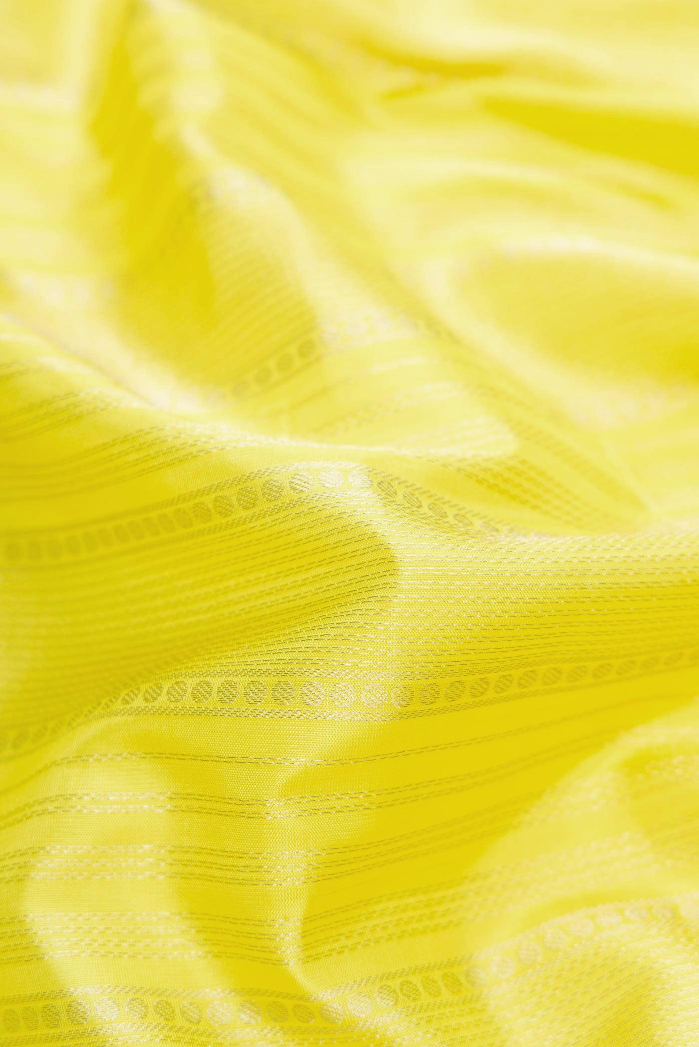Close up of Lemon Yellow Dual Tone Soft Silk Saree with Stripes on the body and Zari Border.  displaying folds
