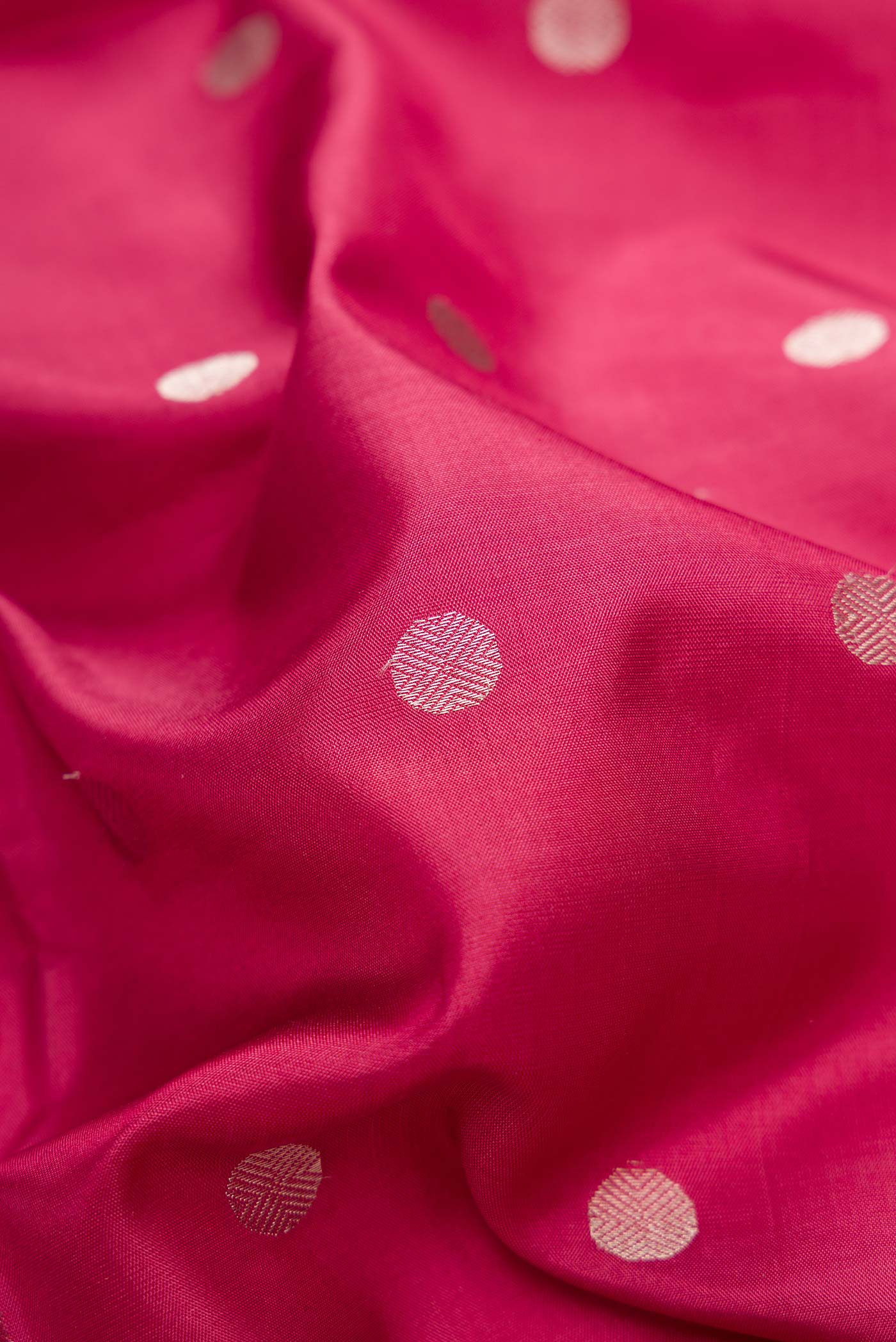 Close up of Dark Pink Dual Tone Kanchipuram Silk Saree with Zari Butta on the body and Zari Border.  displaying folds