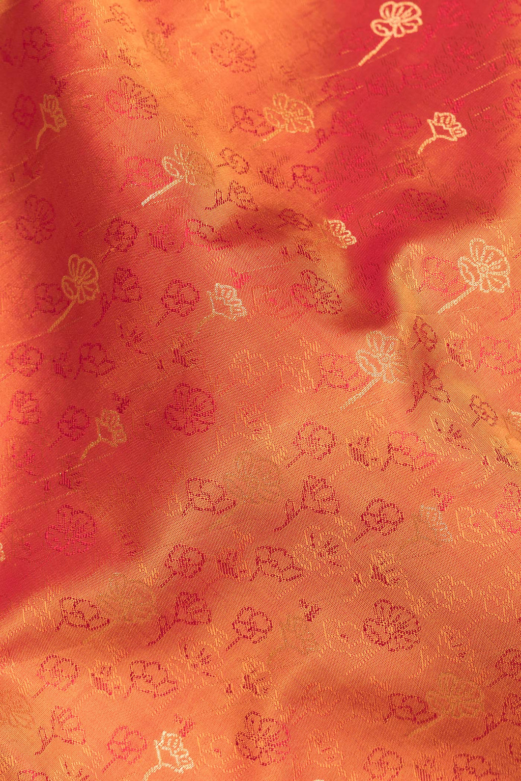 Close up of Pure Silk Orange Soft Saree with Jacquard With Zari Butta on the body and Without Border.  displaying folds