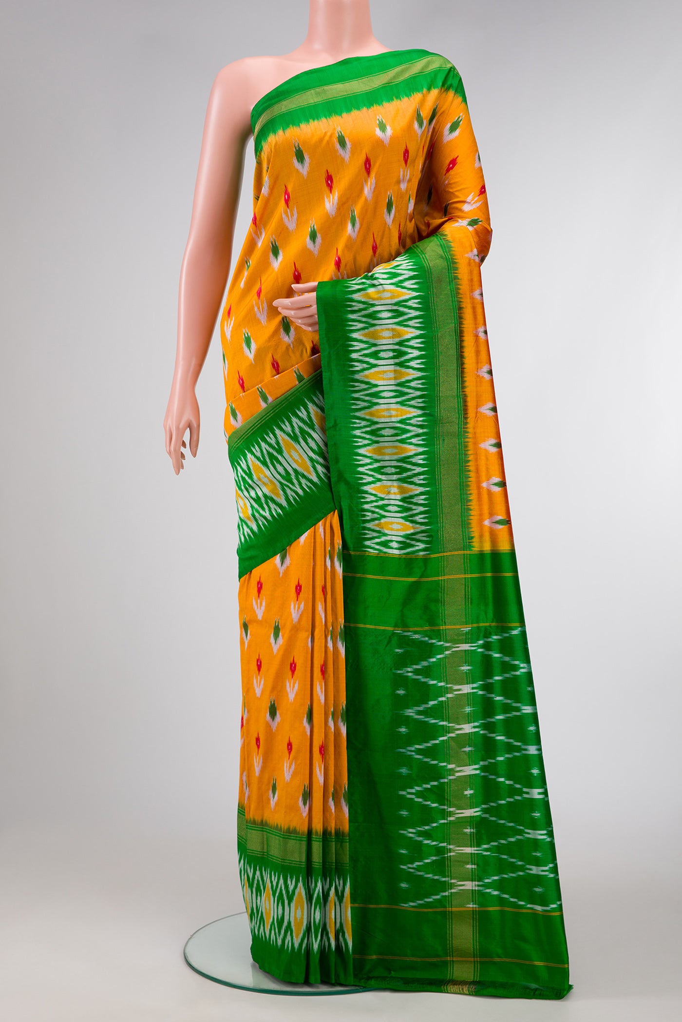 Mustard Dual Tone Double Ikat Saree with Ikat Print on the body and Zari Border.  displayed on a mannequin