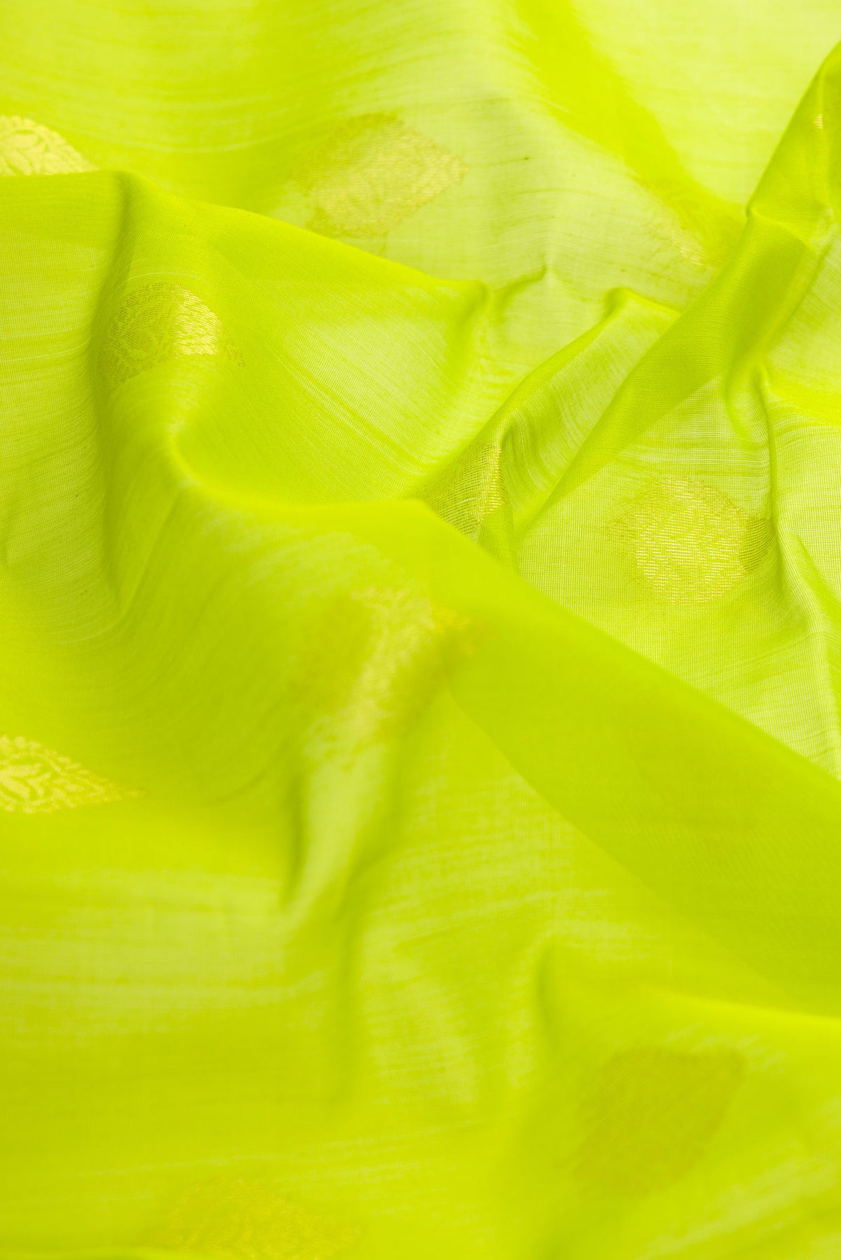 Close up of Parrot Green Dual Tone Silk Cotton Saree with Zari Butta on the body and Zari Border displaying folds
