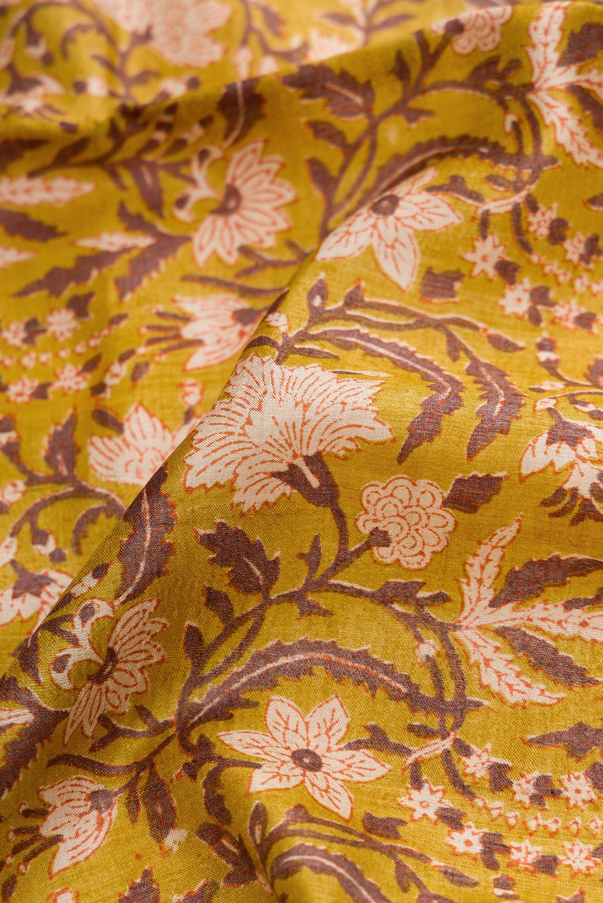 Close up of Mehandi Green Dual Tone Tussar Silk Saree with Printed design on the body and Zari Border.  displaying folds