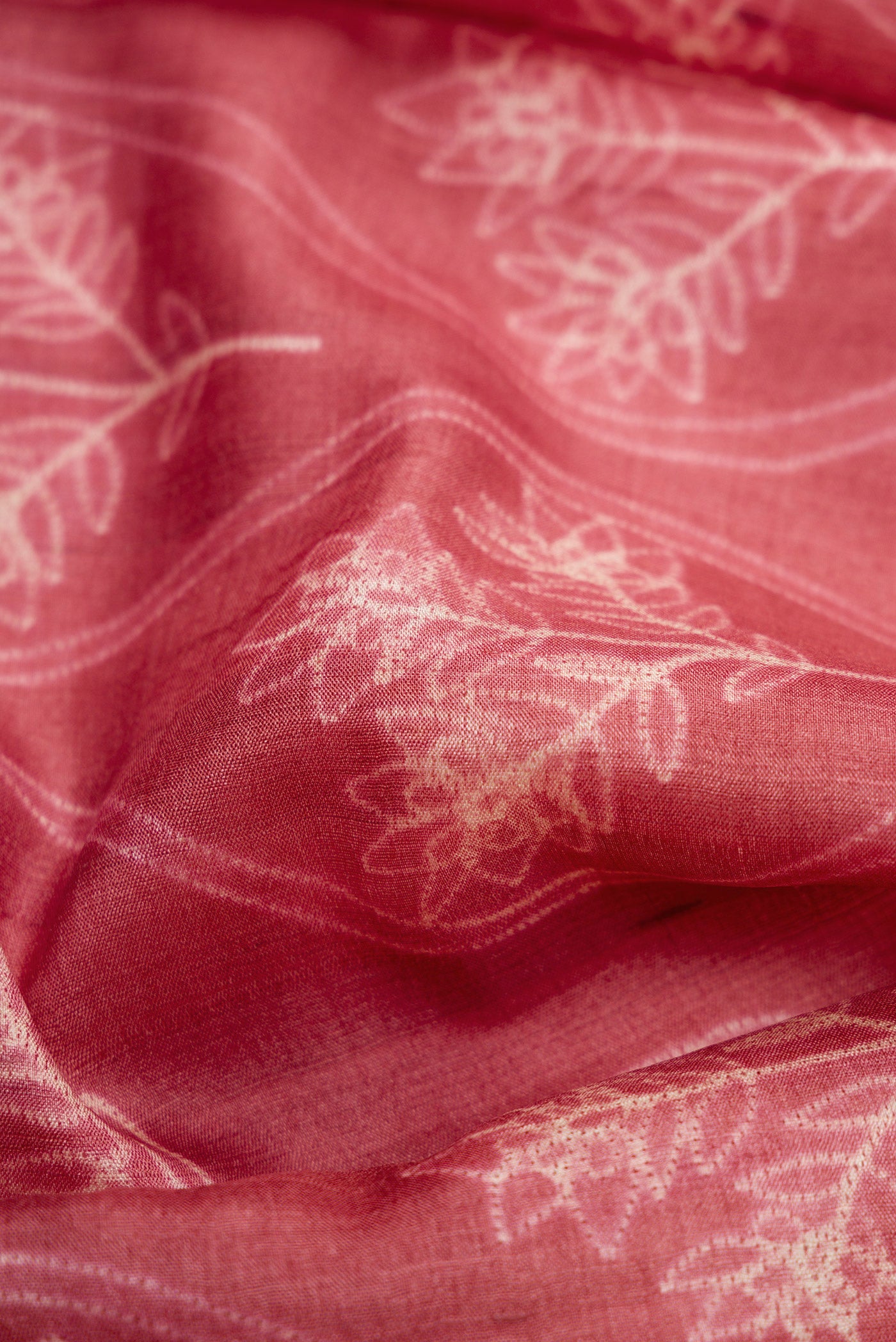 Close up of Pink Dual Tone Tussar Silk Saree with Printed design on the body and Embroidery Border.  displaying folds