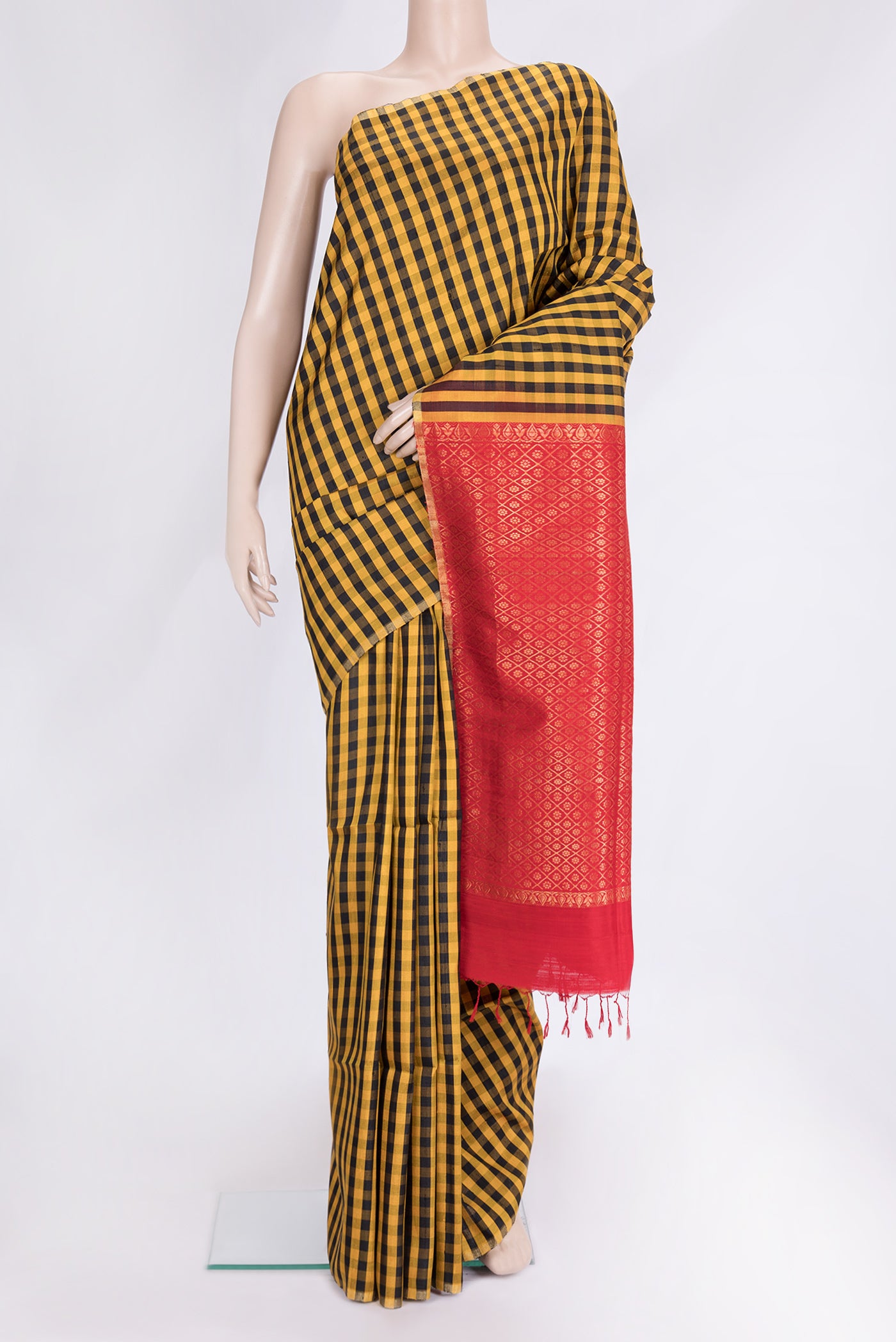 Black and Mustard Color Raw Silk Saree with Checked design on the body and Thin Zari Line.  displayed on a mannequin