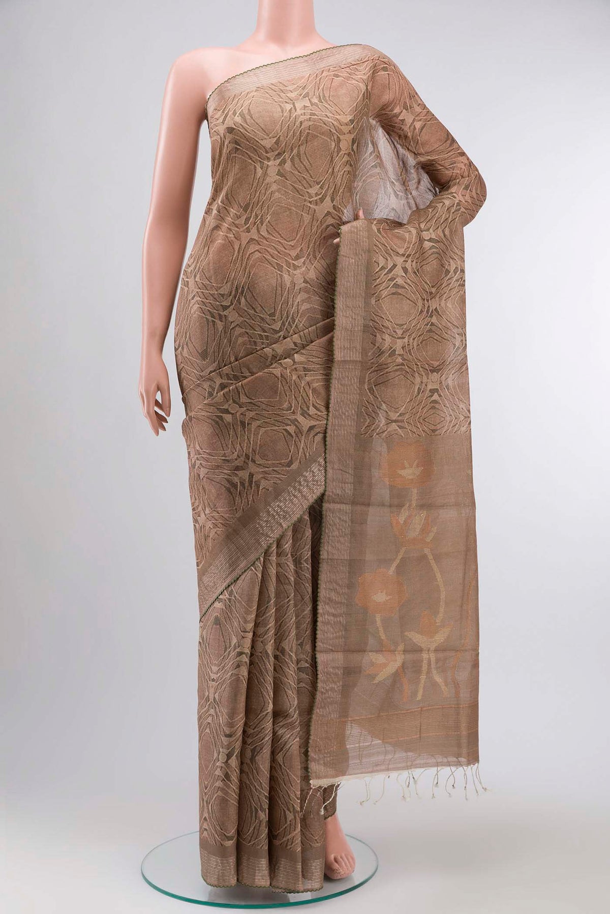 Dark Beige Tussar Silk Saree with Printed design on the body and Zari Border displayed on a mannequin