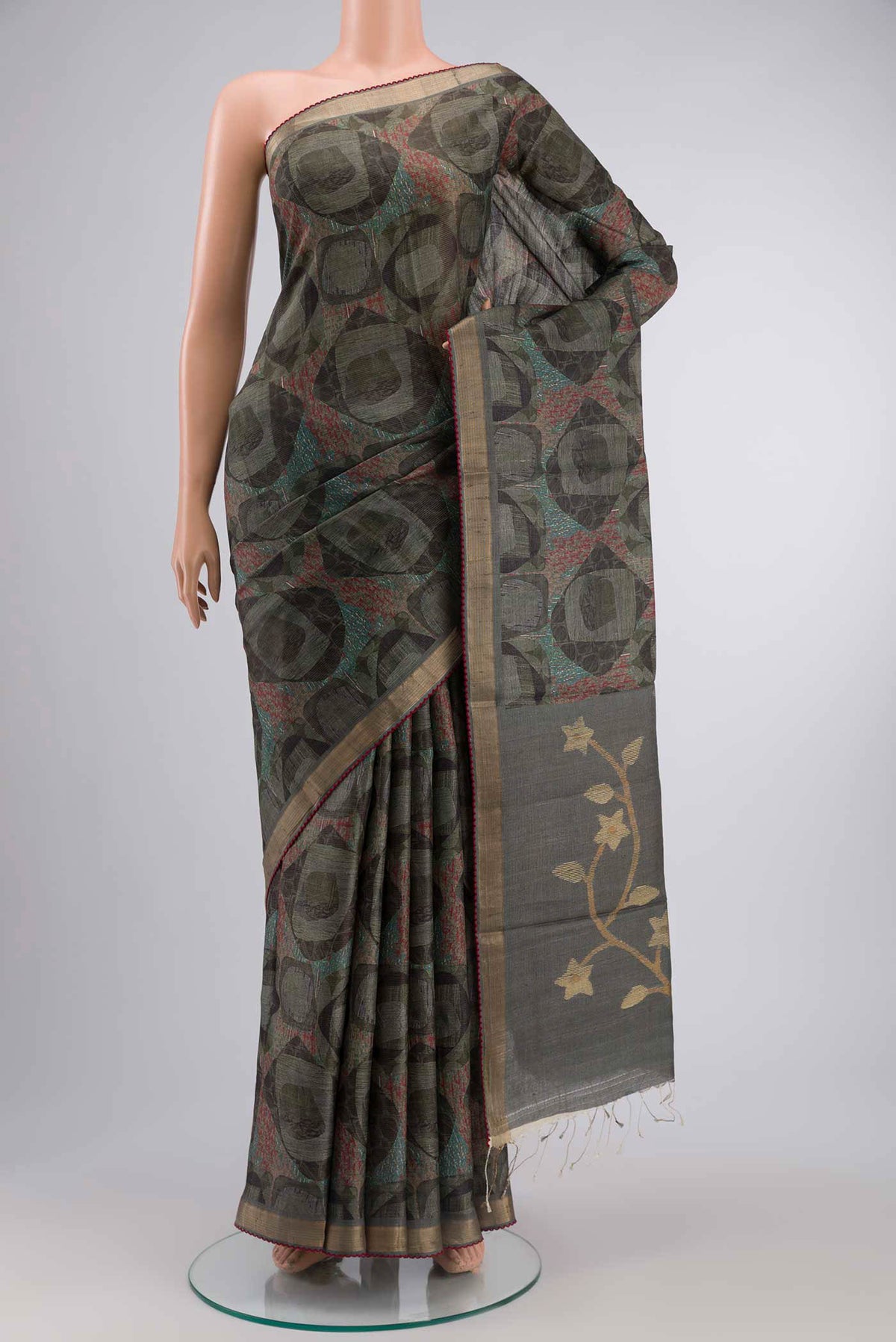 Green Tussar Silk SareePrinted design on the body and Zari Border displayed on a mannequin