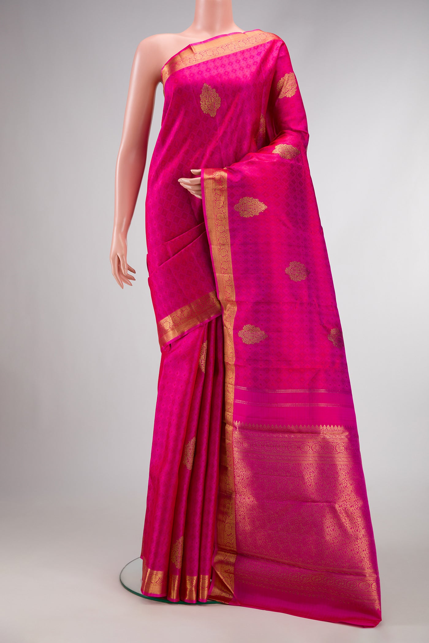 Pure Silk Pure Zari Magenta Dual Tone Kanchipuram Saree with Jacquard With Zari Butta on the body and Zari Border.  displayed on a mannequin