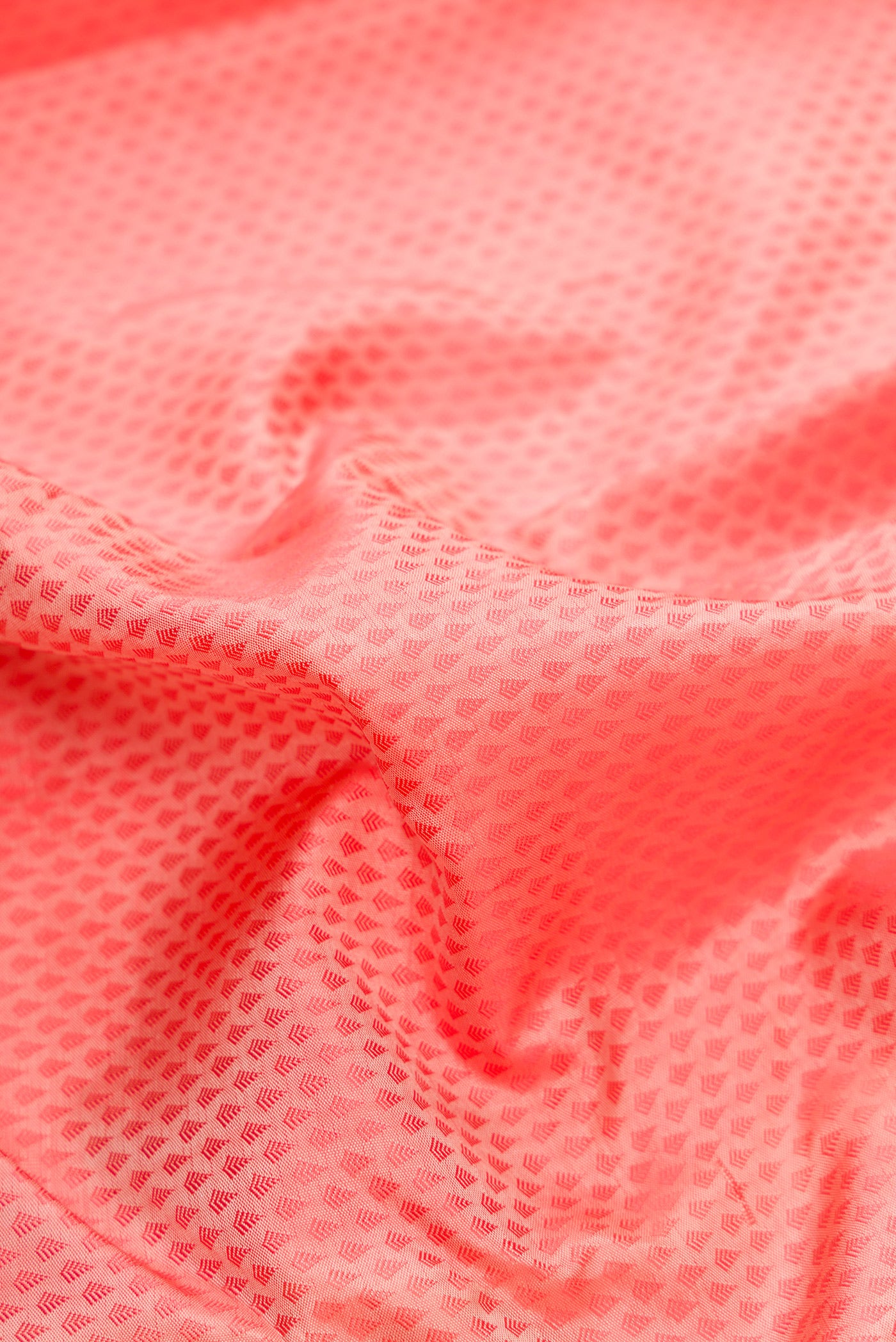 Close up of Peach Dual Tone Kanchipuram Silk Saree with Jacquard design on the body and Zari Border.  displaying folds
