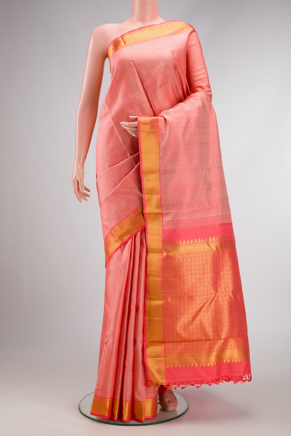 Peach Dual Tone Kanchipuram Silk Saree with Jacquard design on the body and Zari Border.  displayed on a mannequin