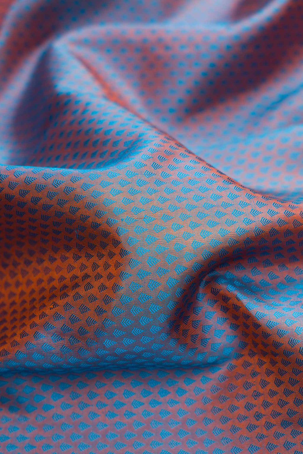 Close up of Peacock Blue Dual Tone Kanchipuram Silk Saree with Jacquard design on the body and Zari Border.  displaying folds
