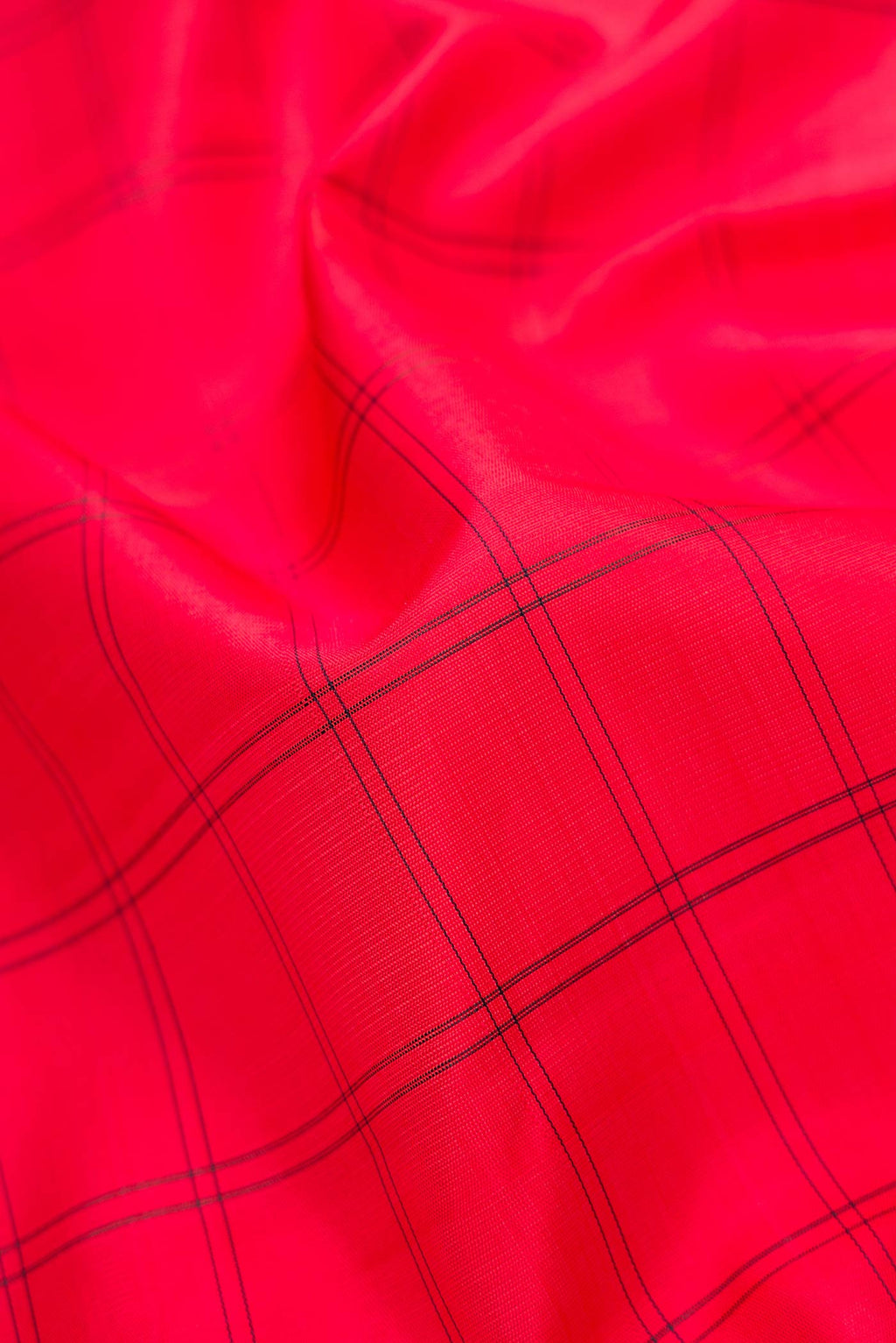 Close up of Red Dual Tone Kanjivaram Silk Saree with Checked design on the body and Zari Border.  displaying folds