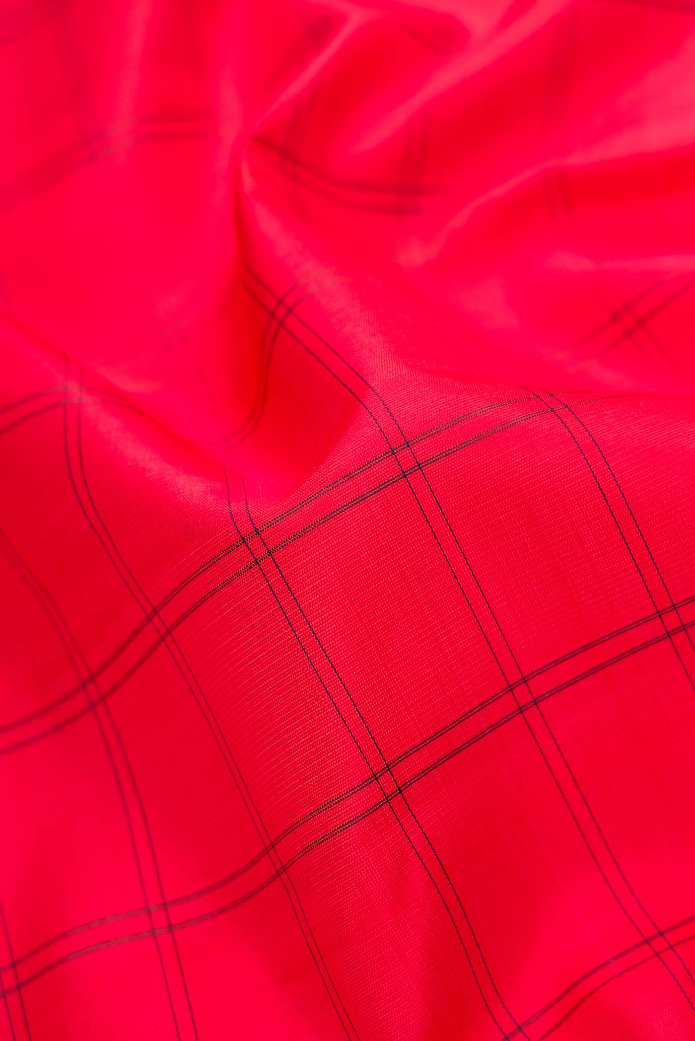Close up of Red Dual Tone Kanjivaram Silk Saree with Checked design on the body and Zari Border.  displaying folds