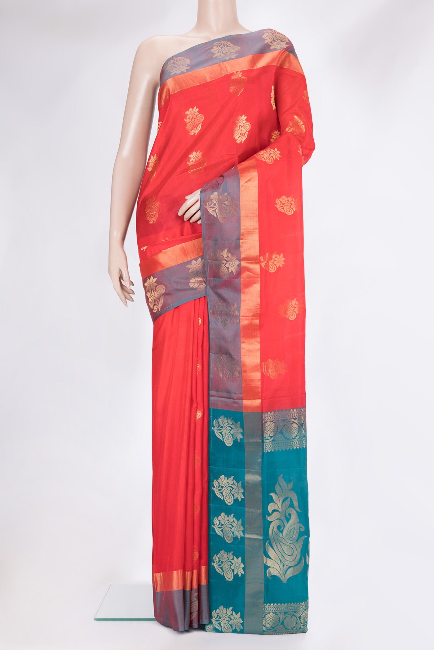 Orange Soft Silk Saree with Zari Butta on the body and Fancy Border.  displayed on a mannequin