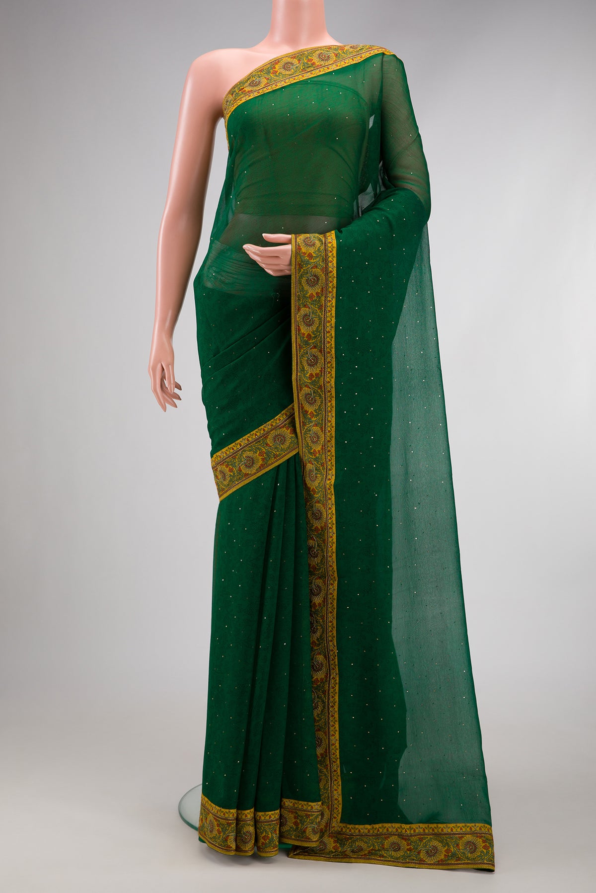 Bottle Green Chiffon Saree with Embroidery on the body and Thread Border.  displayed on a mannequin
