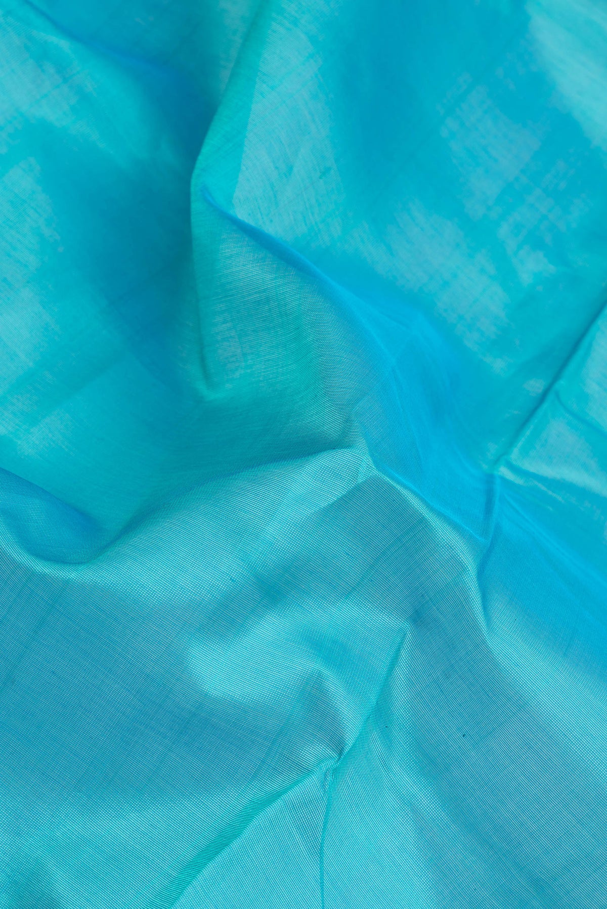 Close up of Sky Blue Silk Cotton Saree with Plain Body and Zari Border.  displaying folds