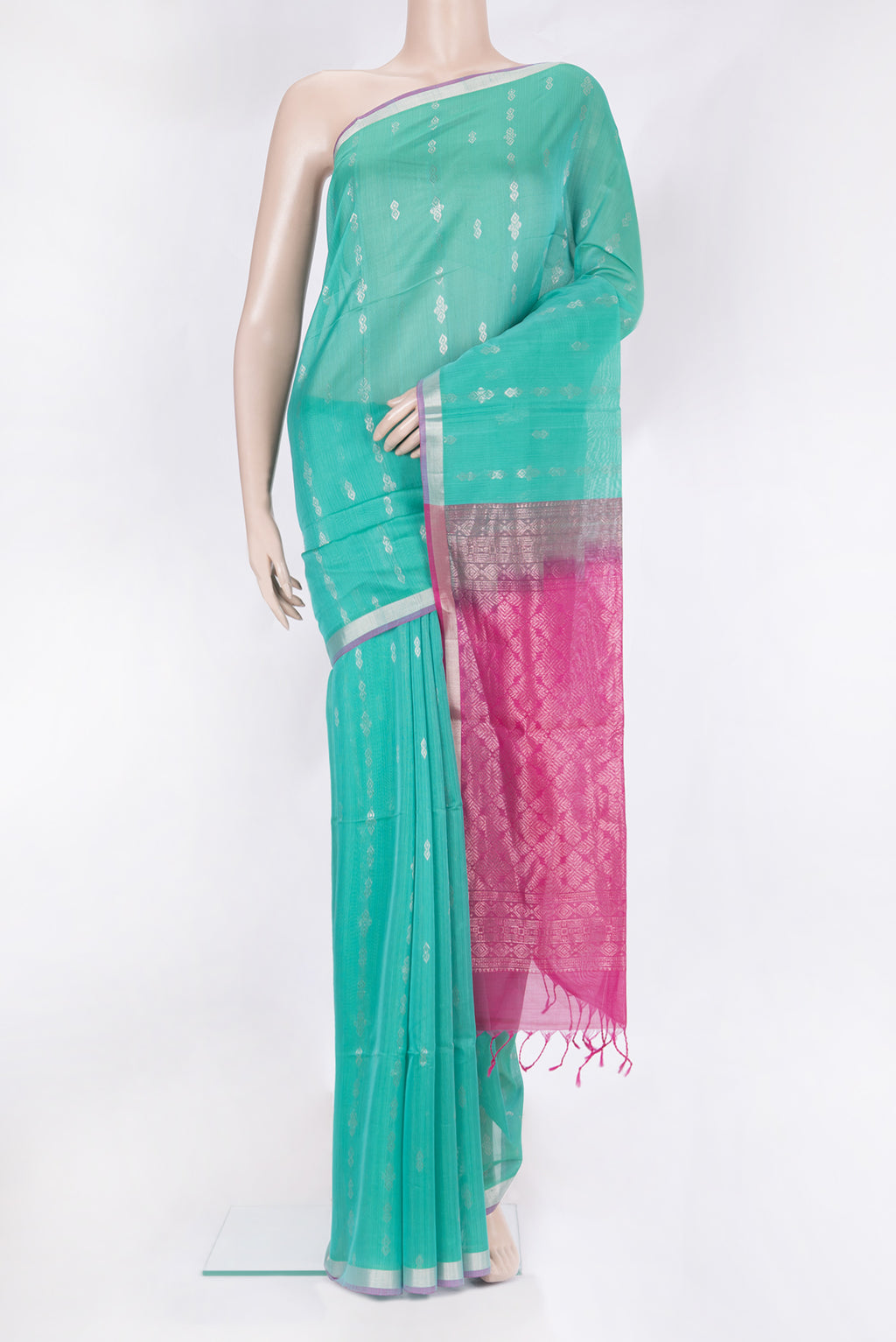 Sea Green Silk Cotton Saree with Zari Butta on the body and Zari Border.  displayed on a mannequin