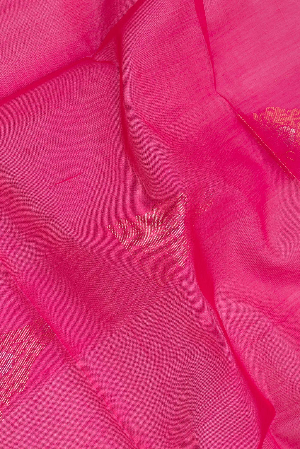 Close up of Dark Pink Silk Cotton Saree with Zari Butta on the body and Zari Border.  displaying folds