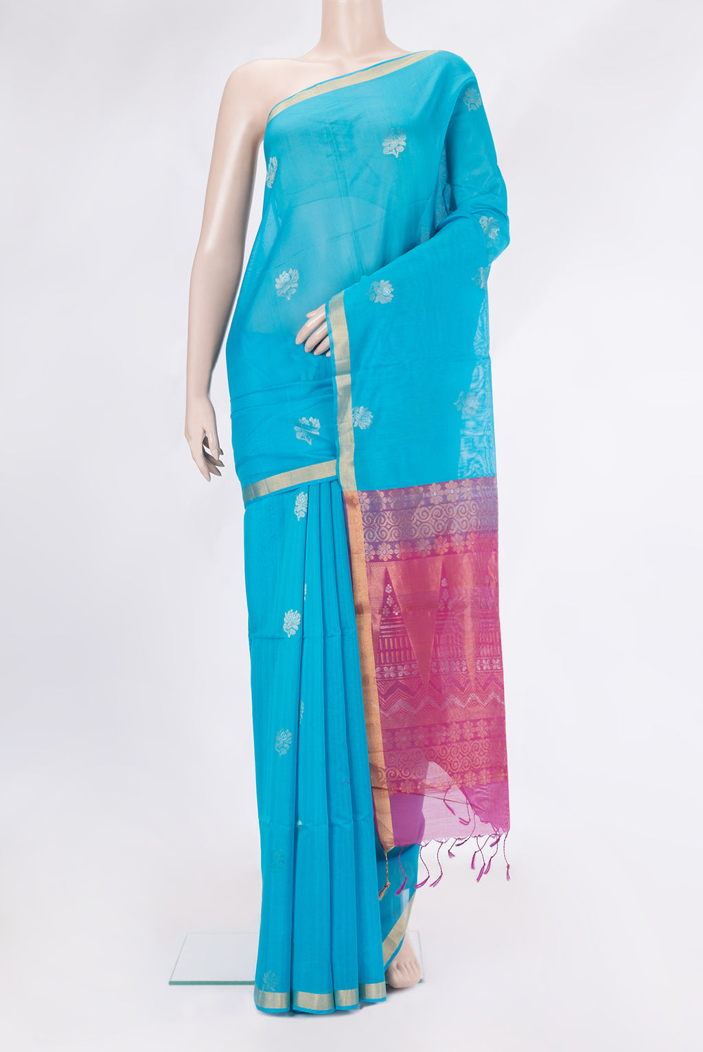 Sky Blue Silk Cotton Saree with Zari Butta on the body and Zari Border.  displayed on a mannequin