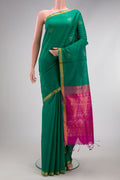 Green Silk Cotton Saree with Zari Butta on the body and Zari Border.  displayed on a mannequin