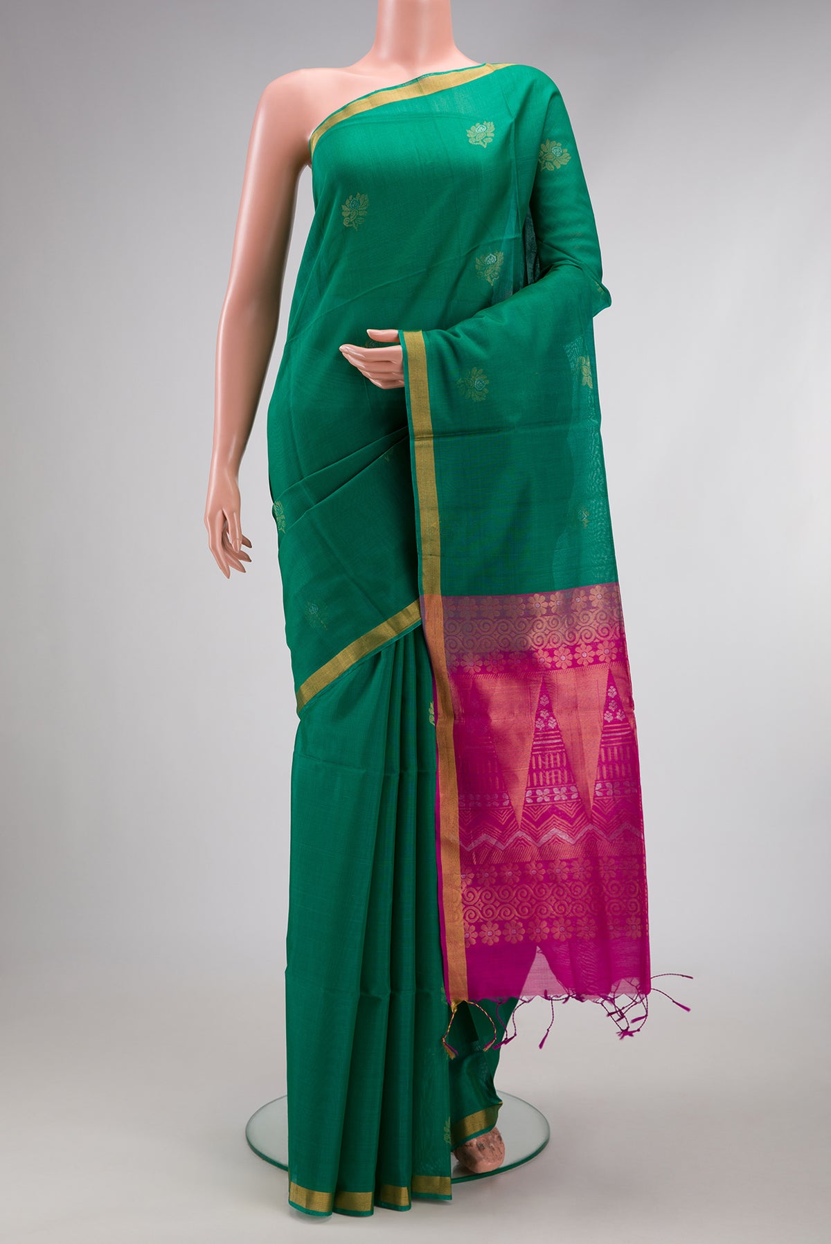 Green Silk Cotton Saree with Zari Butta on the body and Zari Border.  displayed on a mannequin