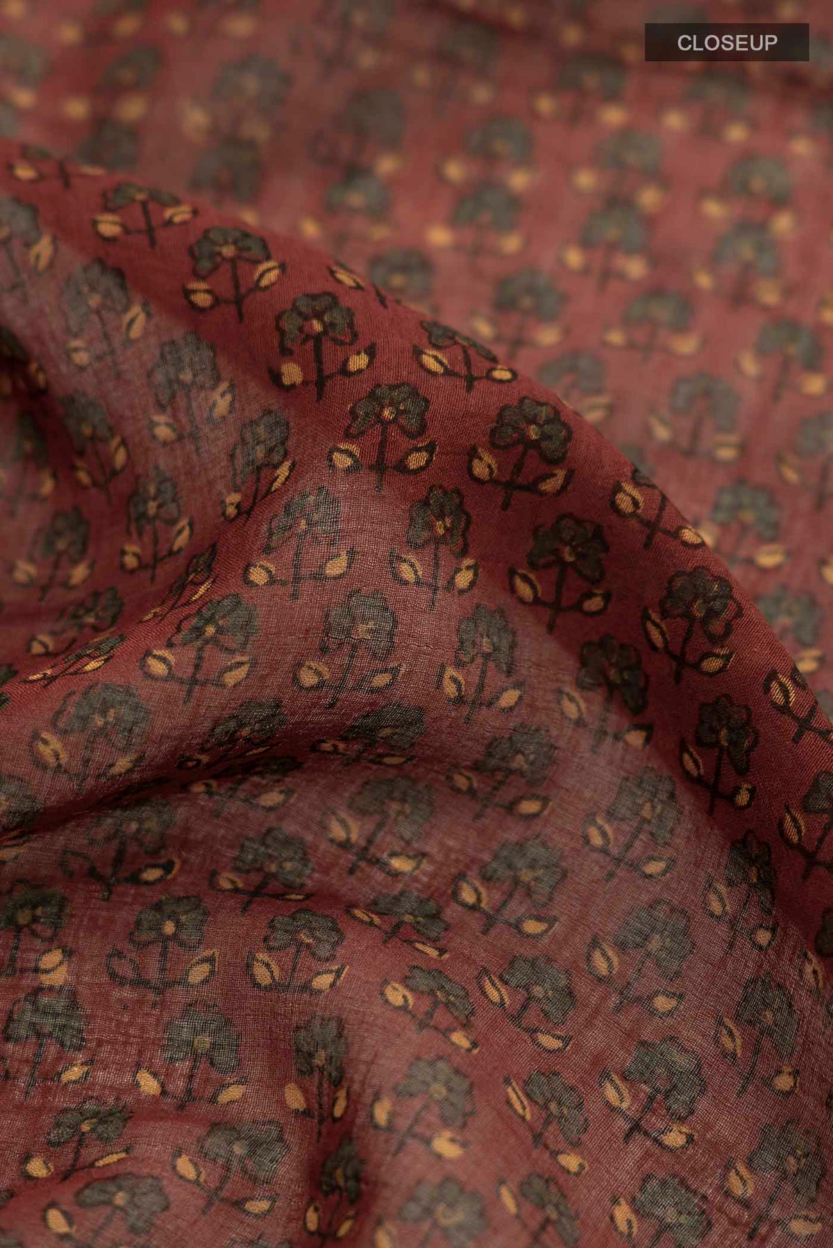 Close up of Rust Chanderi Silk Cotton SareePrinted design on the body and Zari Border displaying folds