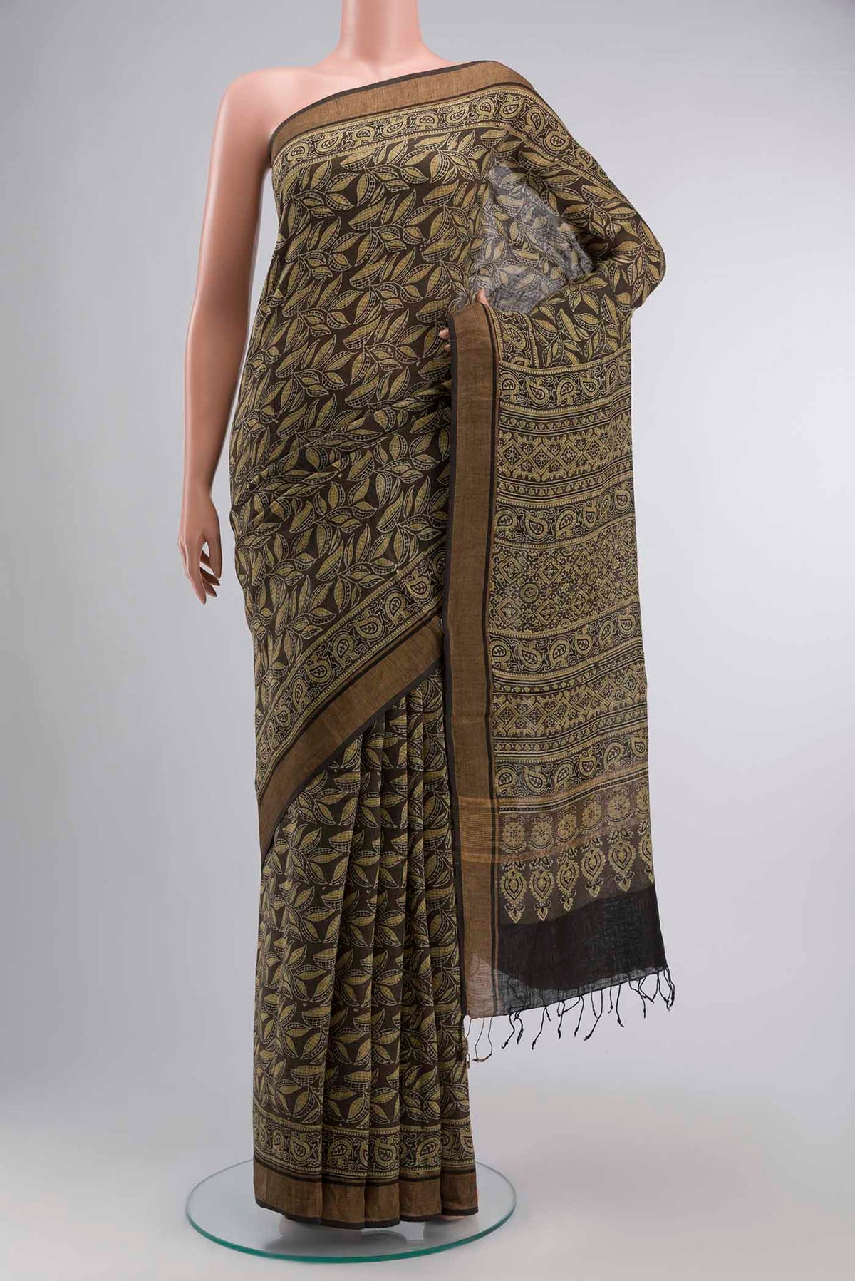 Green Linen Cotton SareePrinted design on the body and Zari Border displayed on a mannequin