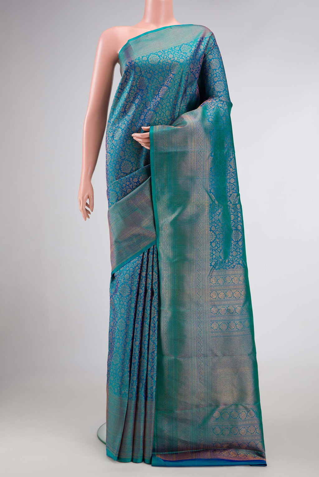 Peacock Blue Dual Tone Kanjivaram Silk Saree with Zari Brocade on the body and Zari Border.  displayed on a mannequin