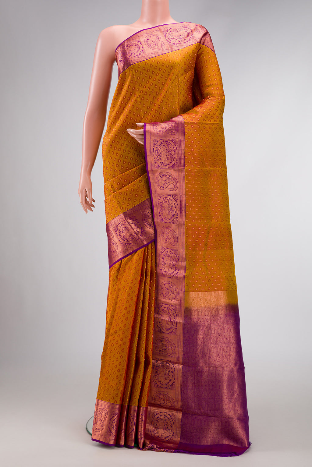 Mustard Dual Tone Kanjivaram Silk Saree with Jacquard design on the body and Zari Border.  displayed on a mannequin