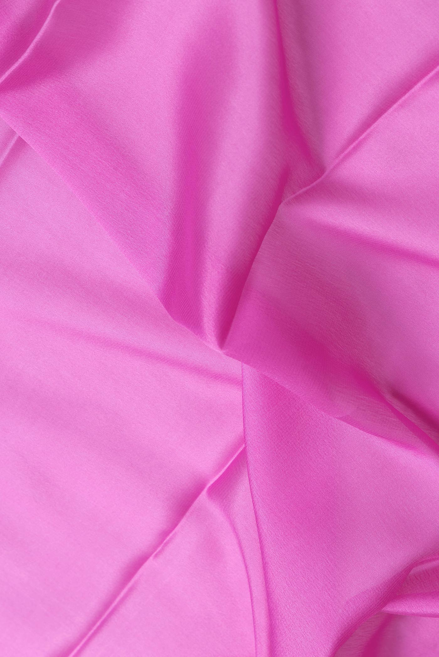 Close up of Pink Dual Tone Mysore Silk Saree with Plain Body and Zari Border.  displaying folds