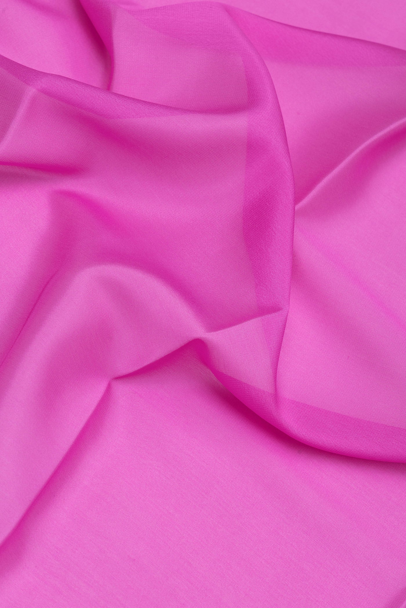 Close up of Pink Mysore Silk Saree with Plain Body and Zari Border.  displaying folds