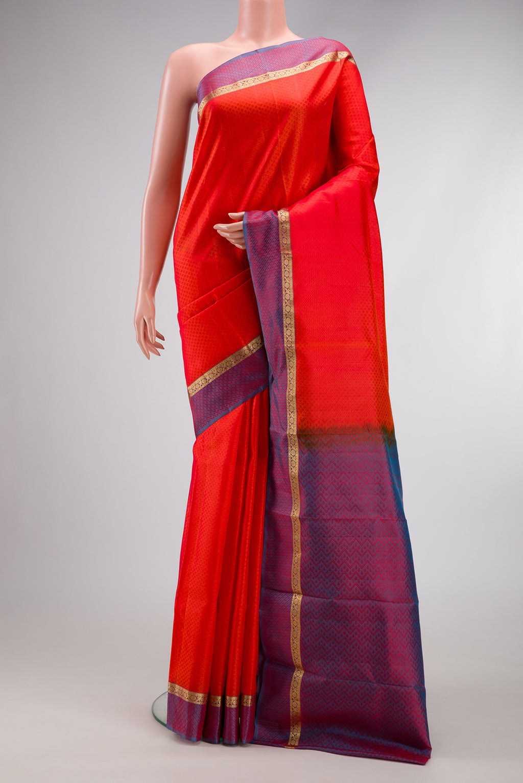 Orange Dual Tone Kanchipuram Silk Saree with Jacquard design on the body and Zari And Thread Border.  displayed on a mannequin