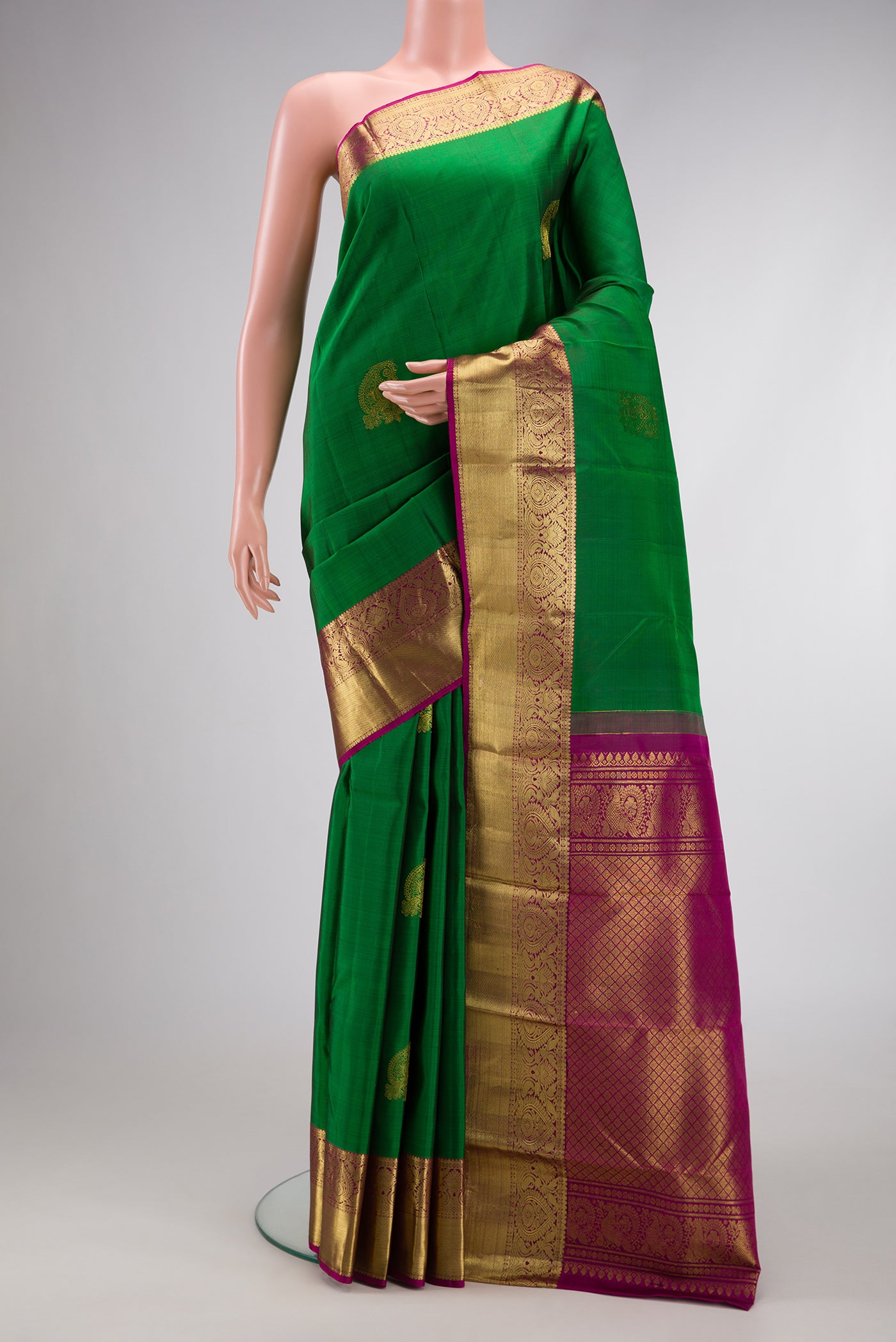 Green Dual Tone Kanchipuram Silk Saree with Zari Butta on the body and Zari Border.  displayed on a mannequin