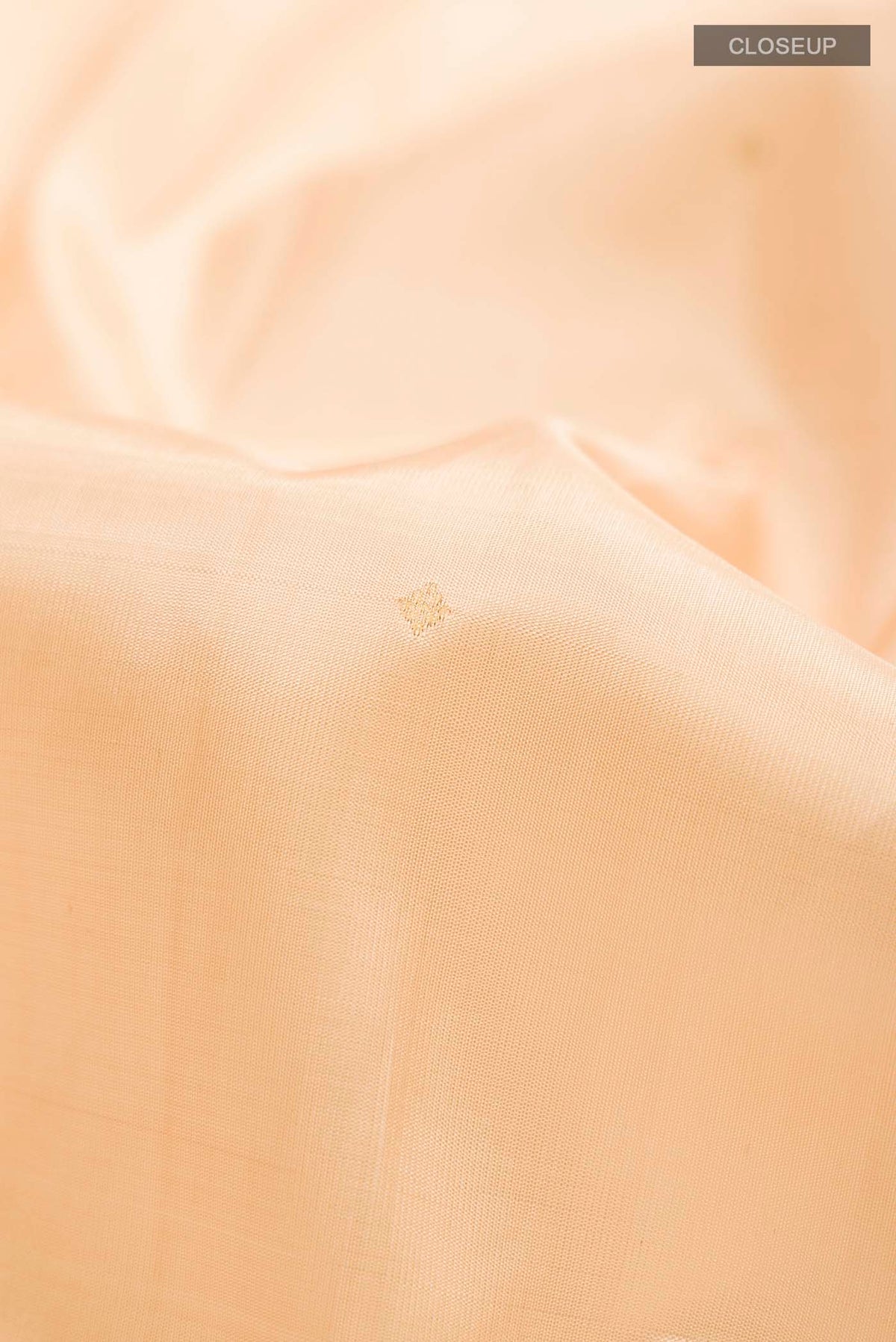 Close up of Sandal Kanchipuram Silk Saree with Zari Butta on the body and Zari Border displaying folds