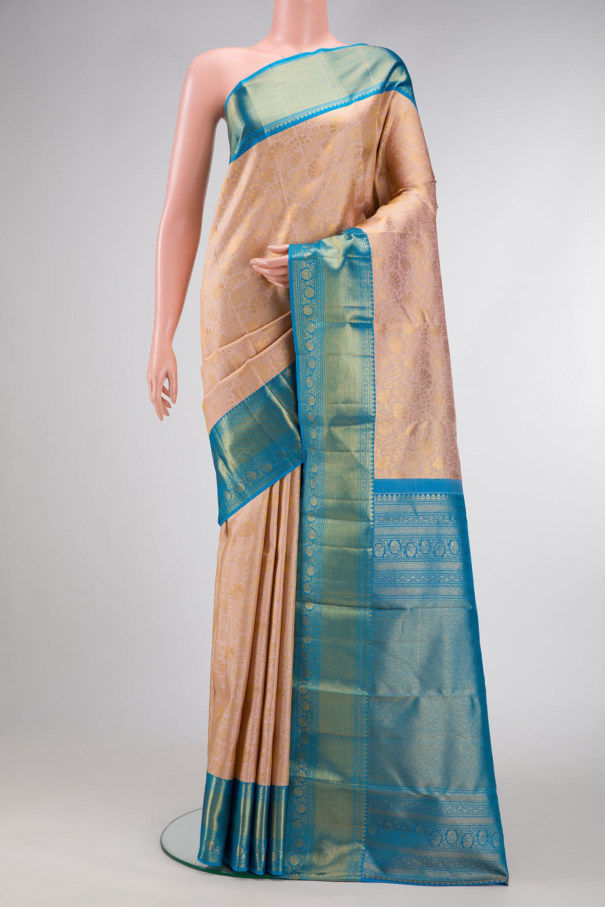 Rose Gold Dual Tone Kanjivaram Silk Saree with Zari Brocade on the body and Zari Border.  displayed on a mannequin
