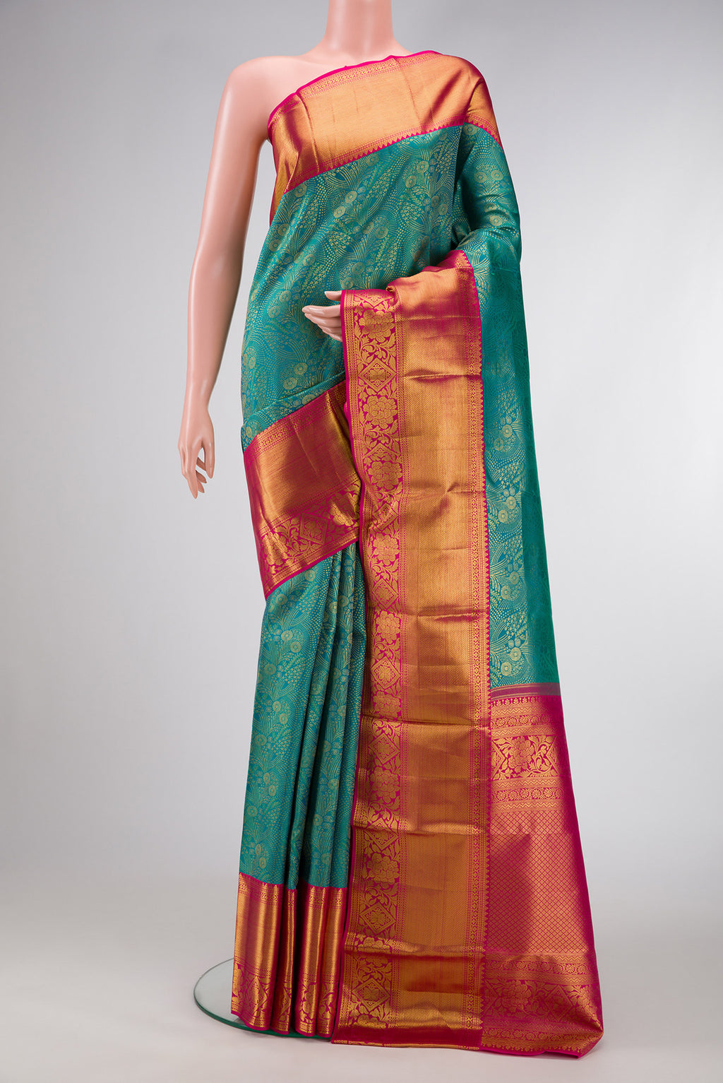 Green Dual Tone Kanjivaram Silk Saree with Zari Brocade on the body and Zari Border.  displayed on a mannequin