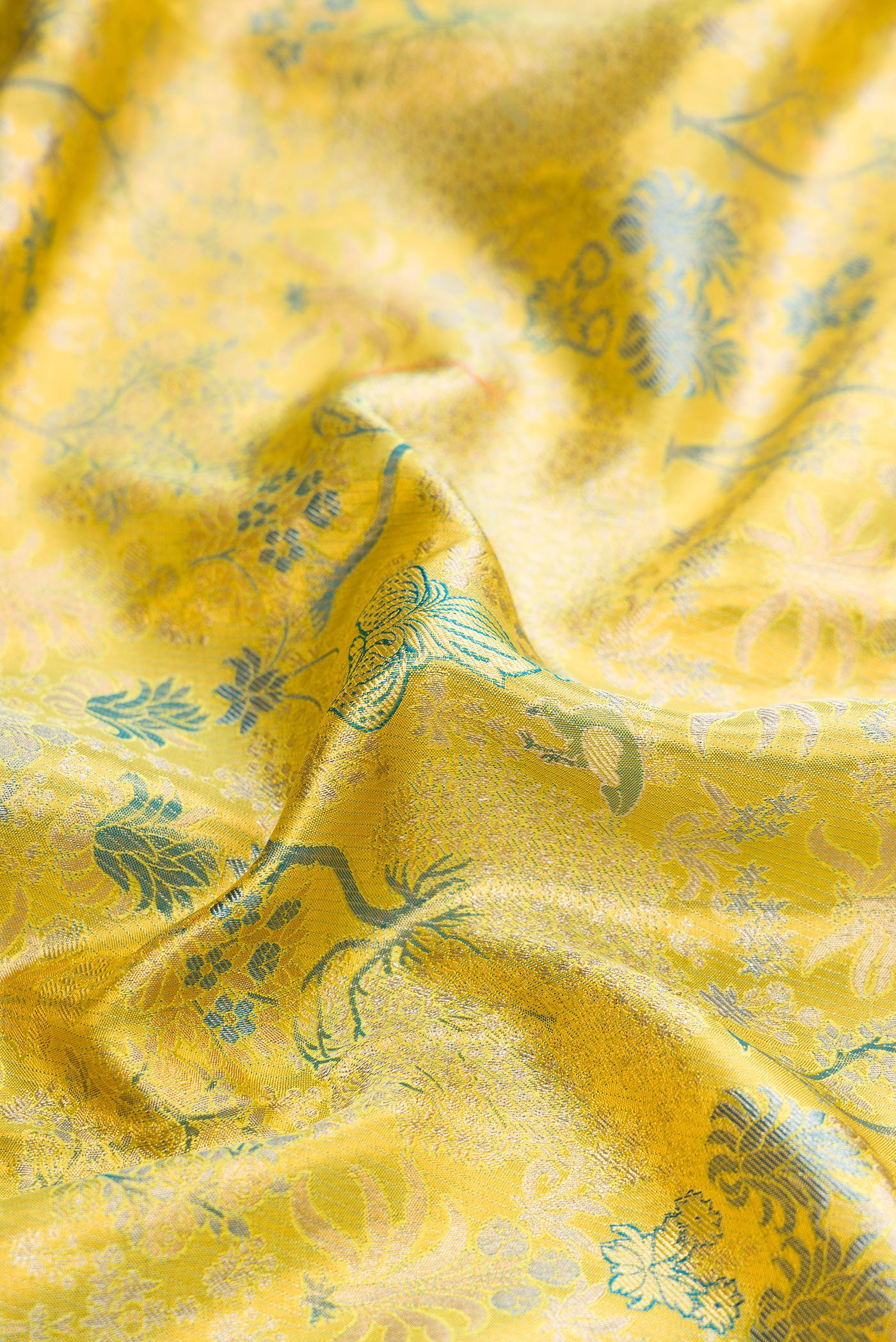 Close up of Green Dual Tone Kanchipuram Tissue Silk Saree with Zari Brocade on the body and Zari Border.  displaying folds