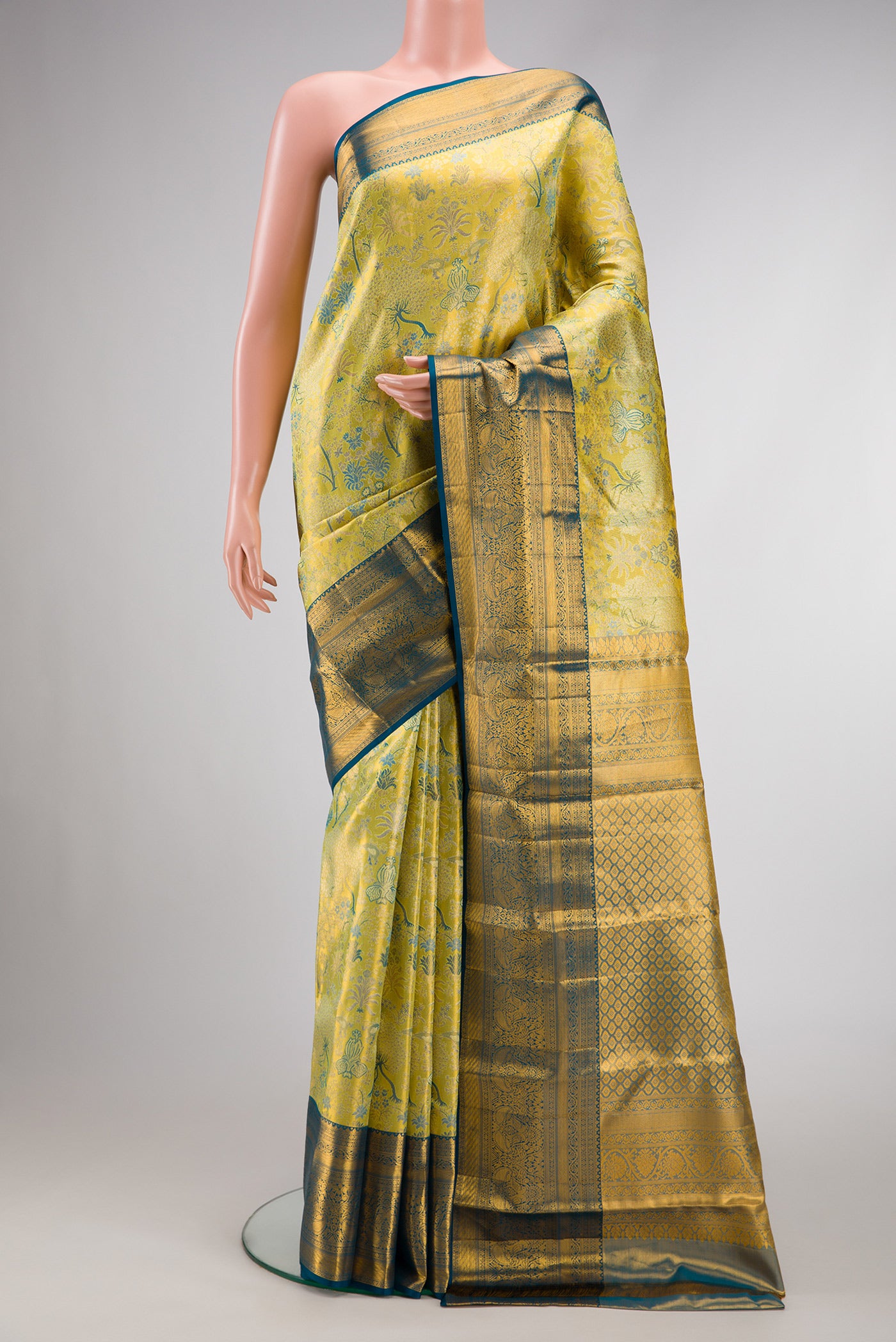 Green Dual Tone Kanchipuram Tissue Silk Saree with Zari Brocade on the body and Zari Border.  displayed on a mannequin