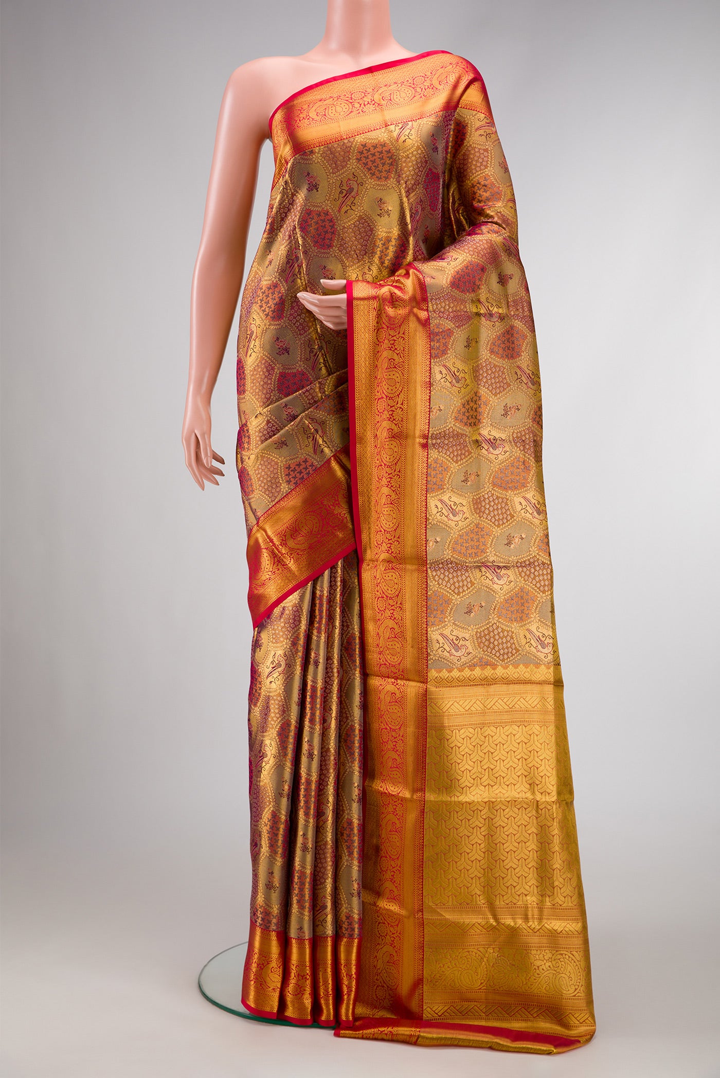 Pure Silk Pure Zari Gold Dual Tone Kanjivaram Tissue Saree with Zari Brocade on the body and Zari Border.  displayed on a mannequin